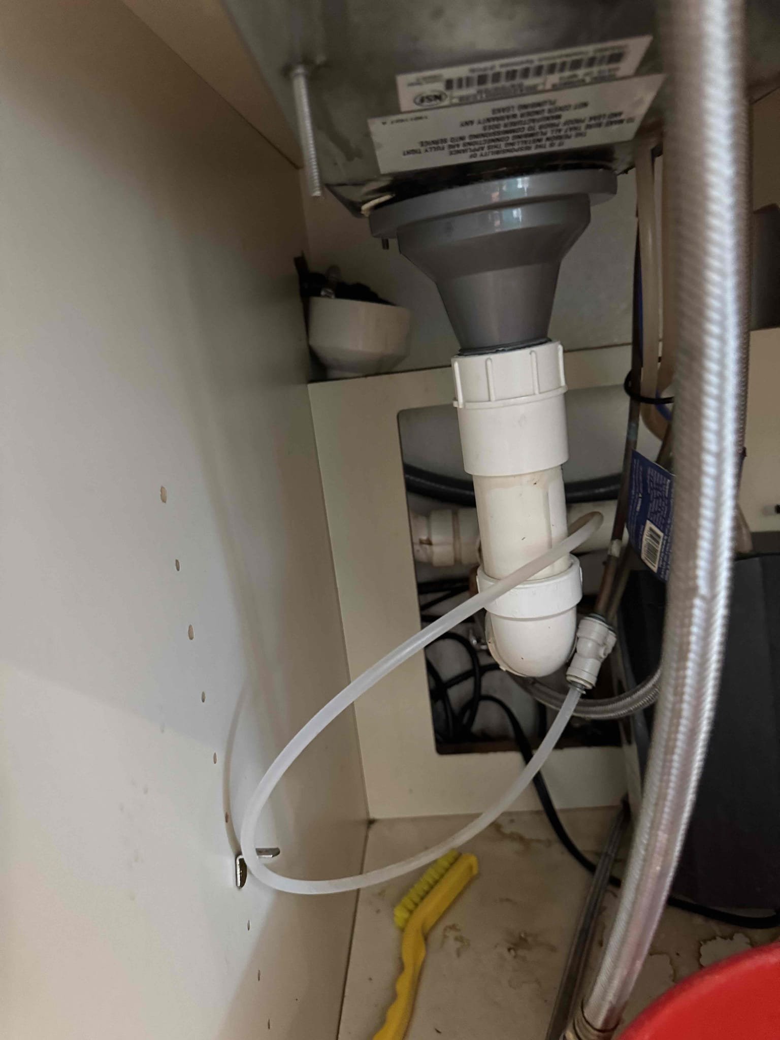 Upon inspection, the espresso machine drain was found to be too short, posing a risk of leaks. To rectify this, I extended the drain using 2 feet of 1/2-inch copper tubing. I then installed a 1-1/2x1-1/2 plastic shark bite 90-degree fitting to ensure a secure connection. Finally, I secured the assembly with a 1-inch hose clamp to prevent any future disconnections. This solution guarantees that the drain will no longer come loose, effectively preventing leaks.