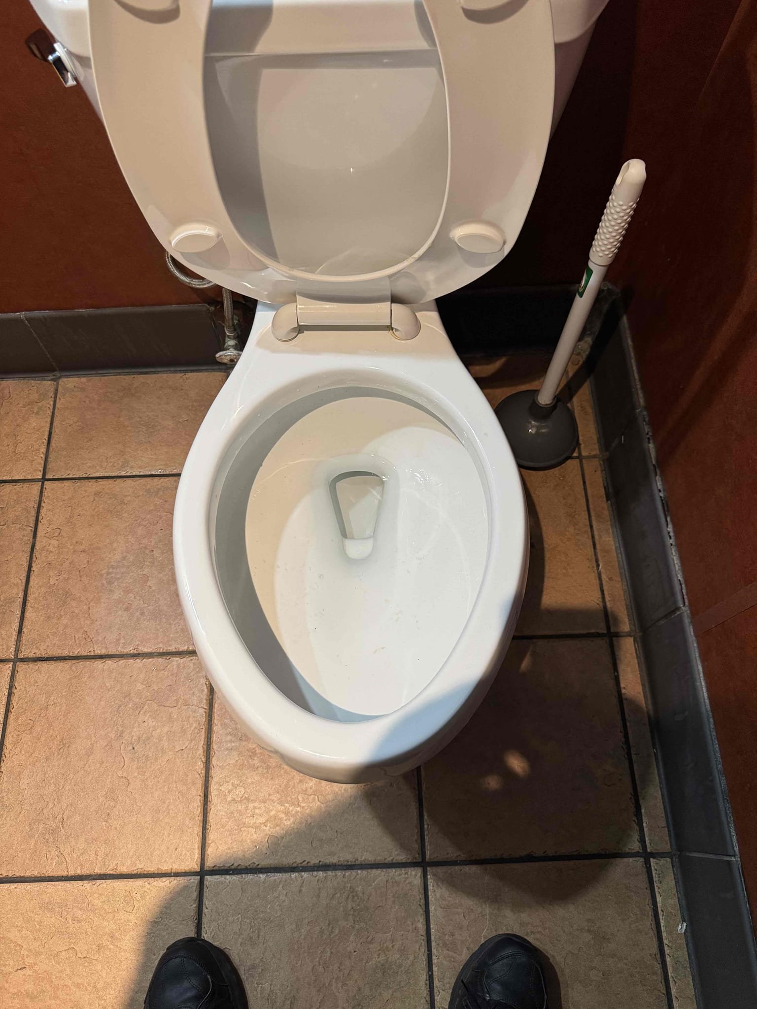Upon arrival, I identified a significant issue with the left bathroom toilet, which was completely clogged with debris. I began by carefully inspecting the toilet to determine the extent of the blockage. Using specialized tools, I methodically removed the accumulated debris, ensuring that all obstructions were cleared. After successfully unclogging the toilet, I tested the flush to confirm that it was functioning properly. With the toilet restored to full functionality, I removed the out of order sign from the door, signaling that the bathroom was ready for use. I completed the job efficiently, leaving the area clean and tidy. I signed for Chriss to confirm the completion of the task.