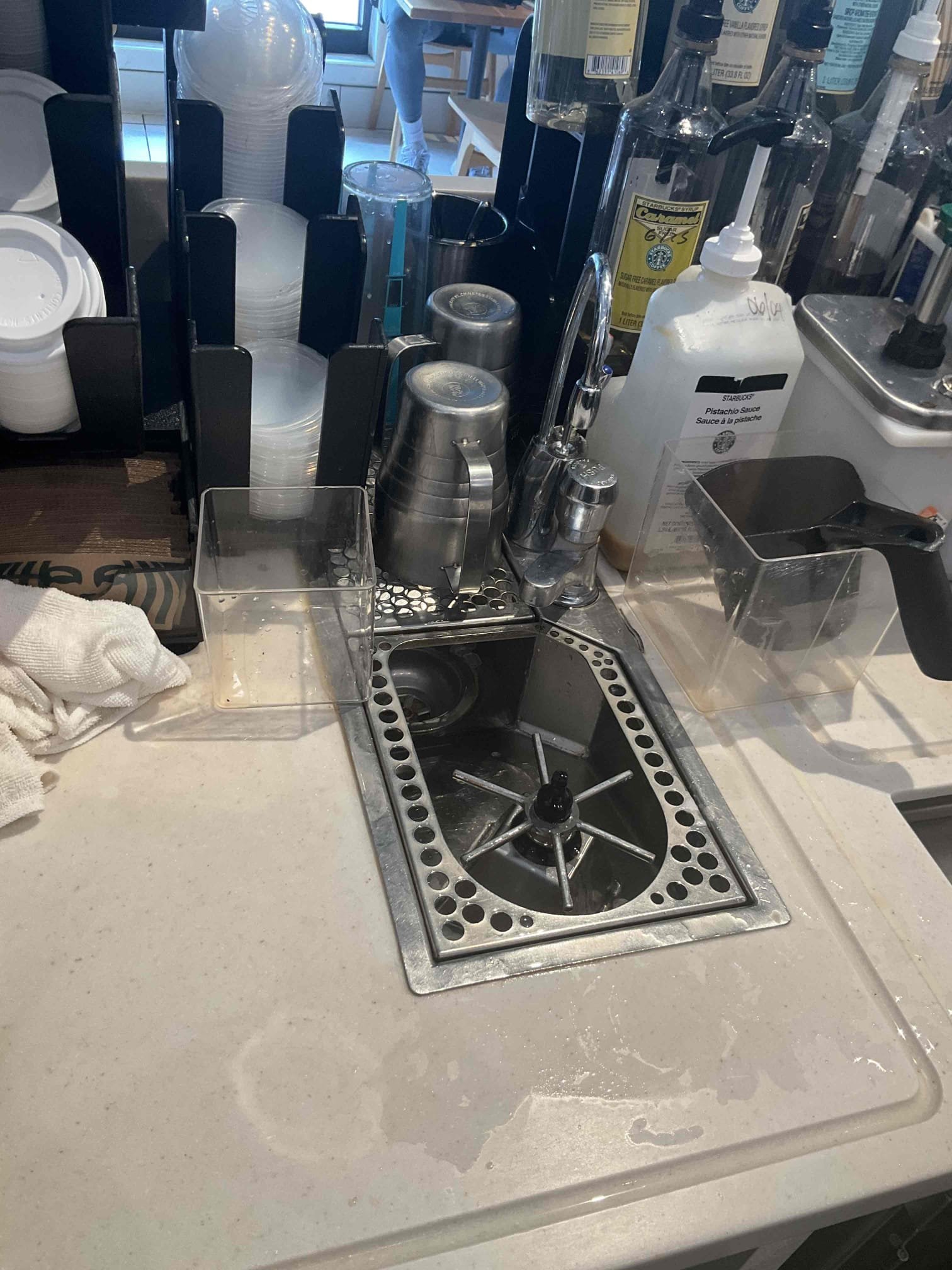 On 5/29, I addressed a foul odor from the Rhino rinse sink drain assembly for bars 2 and 3. After using glug cleaner, the drain was not fully cleaned. I recommended returning after hours to jet out the 1-1/2” PVC drain assembly. On 6/11, I removed all obstructions, inspected the drainage pipe, and used a camera to locate debris. I cleared the debris, flushed the system with additional glug cleaner, and followed with hot water until the floor sink drain basket output was clear.