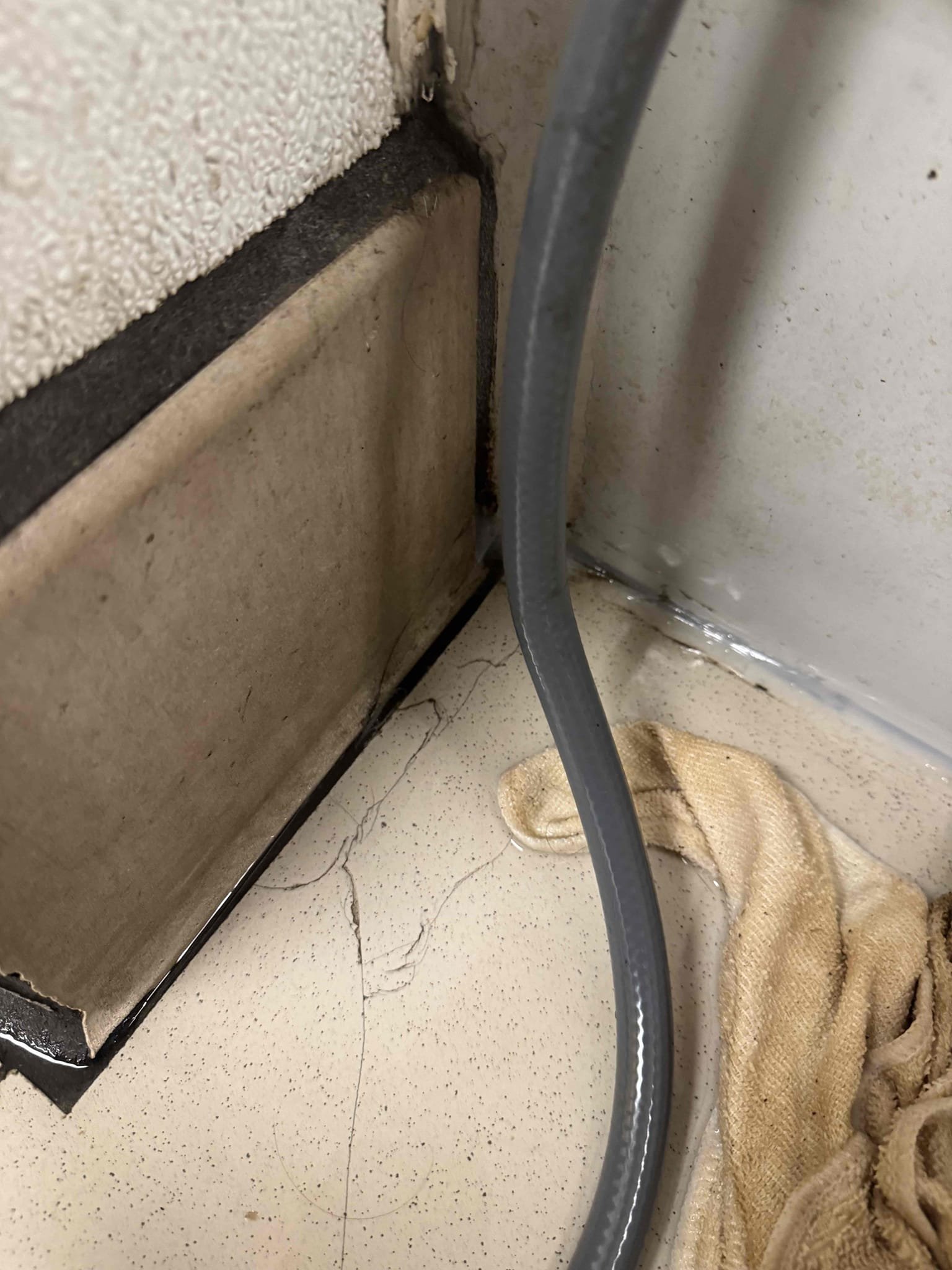 Upon inspection, the mop lock ring and seal were found to be severely damaged, causing the mop sink to leak. The seal had been pushed down around the drain pipe, exacerbating the issue. The constant water flow from the air conditioning machines, which were running continuously, contributed to the leakage. The sink, a standard 24x24 mop sink, required replacement. The surrounding wall and tile corners added complexity to the extraction process, necessitating the assistance of two individuals. The air conditioning machines were removed to facilitate the repair. Following these steps, the mop sink ceased leaking until a replacement could be installed.