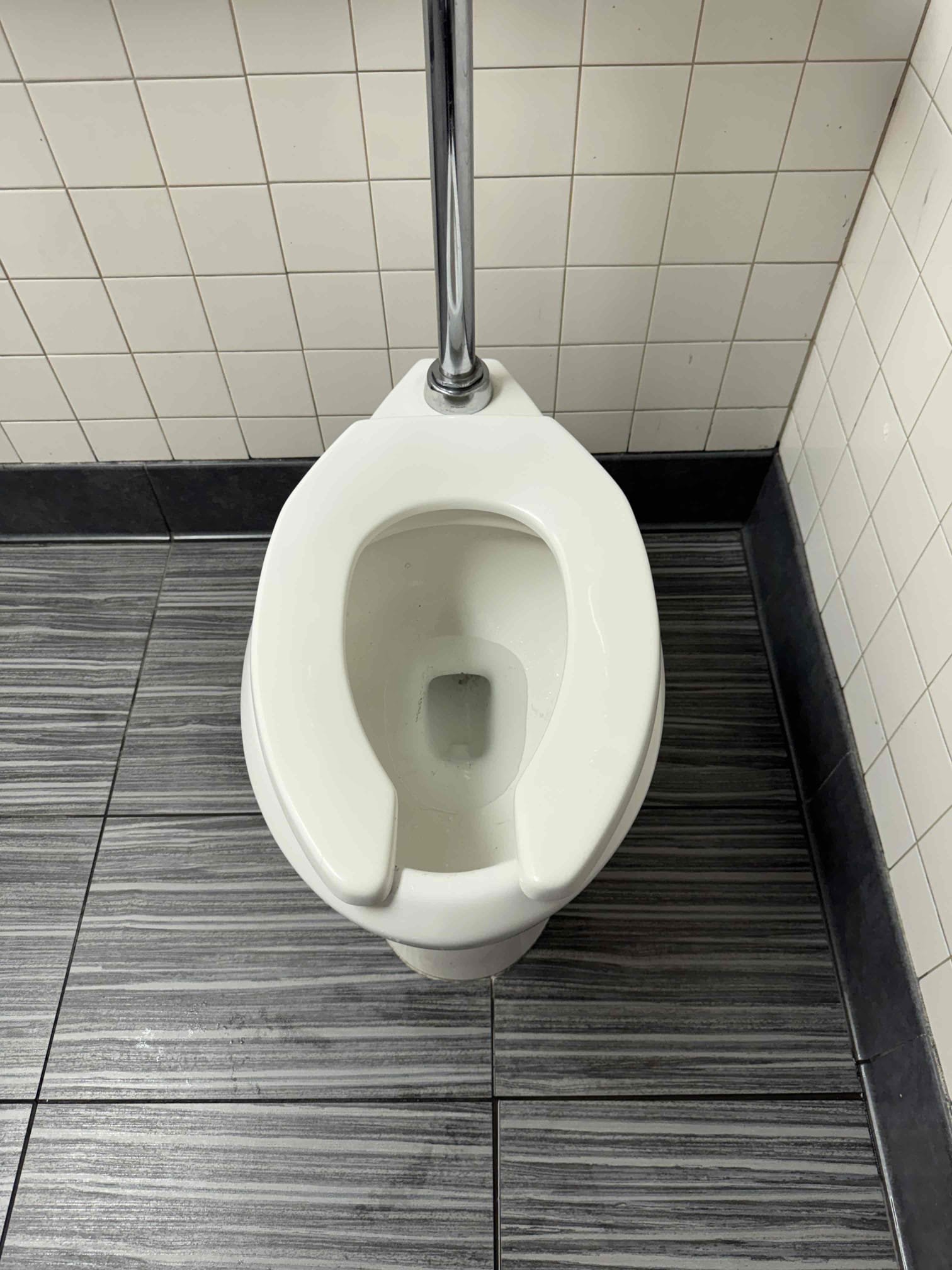 Upon arrival, I assessed the issue with the toilet and identified that paper towels were obstructing the flow. Using an auger, I carefully navigated through the plumbing to dislodge and remove the blockage. After ensuring the auger had cleared the obstruction, I tested the toilet to confirm proper flushing. The toilet functioned as intended, indicating the issue was resolved. I then cleaned the surrounding area, wiping the floor to remove any residual water and ensuring the space was tidy. The job was completed efficiently, restoring full functionality to the toilet.