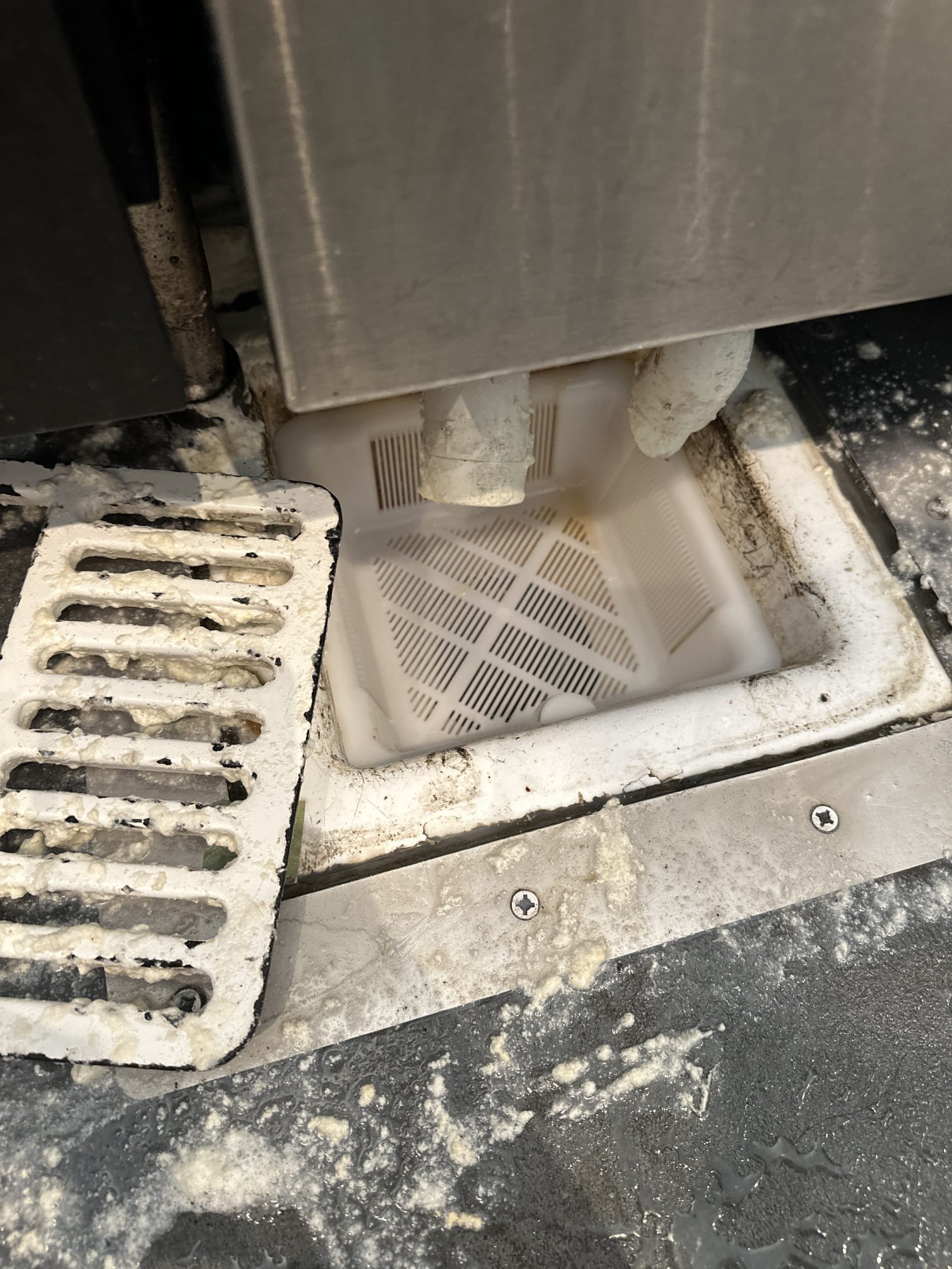 Upon arrival, I met with the manager, Jennifer, who reported a flooding issue caused by a floor sink under the espresso machine. I inspected the floor sink and attempted to run an auger to clear the blockage. Upon closer inspection, I discovered a small clear SB cup obstructing the drain. I carefully removed the cup, allowing the water to drain immediately. To ensure the floor sink was fully functional, I flushed it with several buckets of hot water, which drained without any issues. I then replaced the old, broken basket strainer with a new 12x12 Krown basket strainer, ensuring it was properly installed and effective.