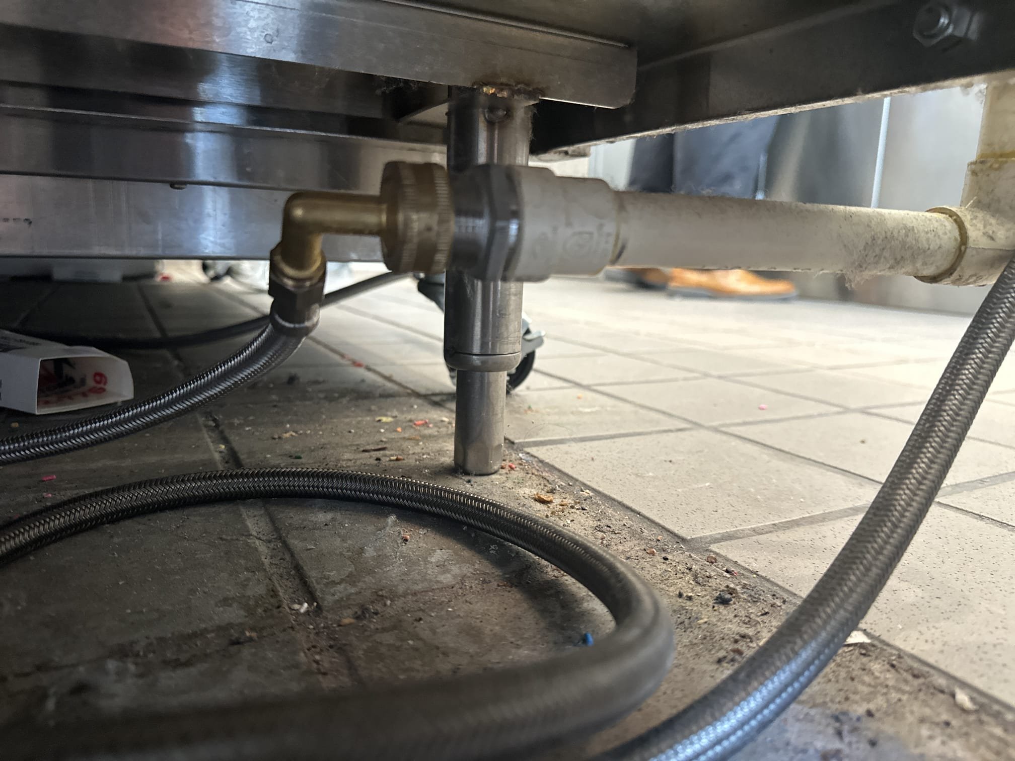 Upon arrival, I inspected the drain for the dipper well faucet, which was connected to a 3/4” CPVC line and a 3/8” supply line. The constant clogging issue was addressed by removing the supply line and adapter. I then installed CPVC piping all the way to the floor sink under the left freezer. The drain was secured, and I ensured the freezer was positioned correctly. The drain is now functioning properly. Parts used included three 3/4” 90-degree CPVC elbows, one 3/4” CPVC coupler, Flo guard CPVC glue, and two 3/4” 2-hole straps.