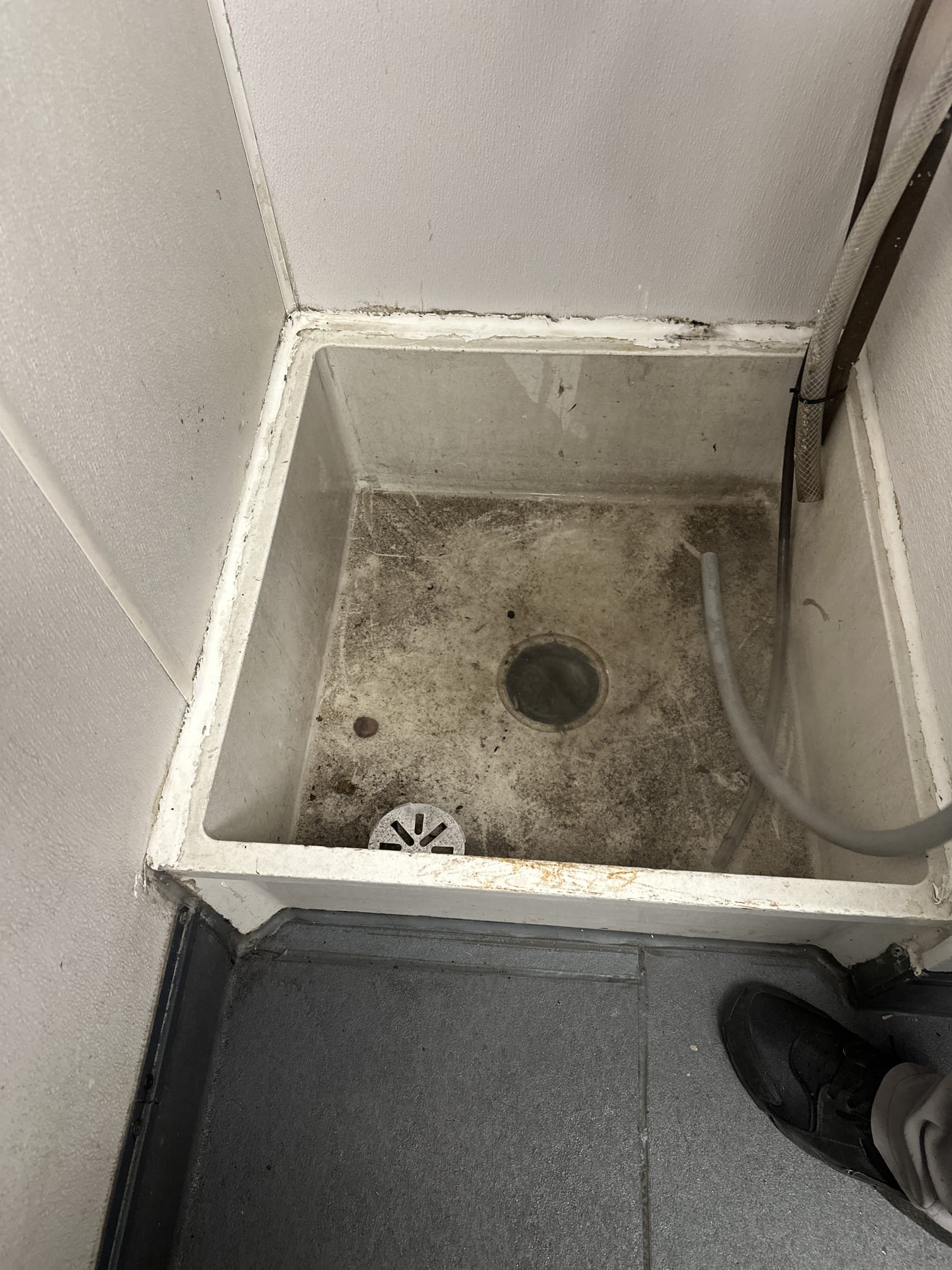 Upon arrival, I conducted a thorough inspection of the mop sink, which was found to be holding water. The drain had a shallow trap, allowing me to easily remove the rag that was causing the clog. I carefully extracted the rag, ensuring no damage was done to the sink or drain. After clearing the clog, I cleaned the mop sink to remove any residue or dirt. To ensure the drain was fully clear, I flushed it with hot water for several minutes, which helped to eliminate any remaining debris in the trap. The mop sink is now fully functional and no longer clogged.