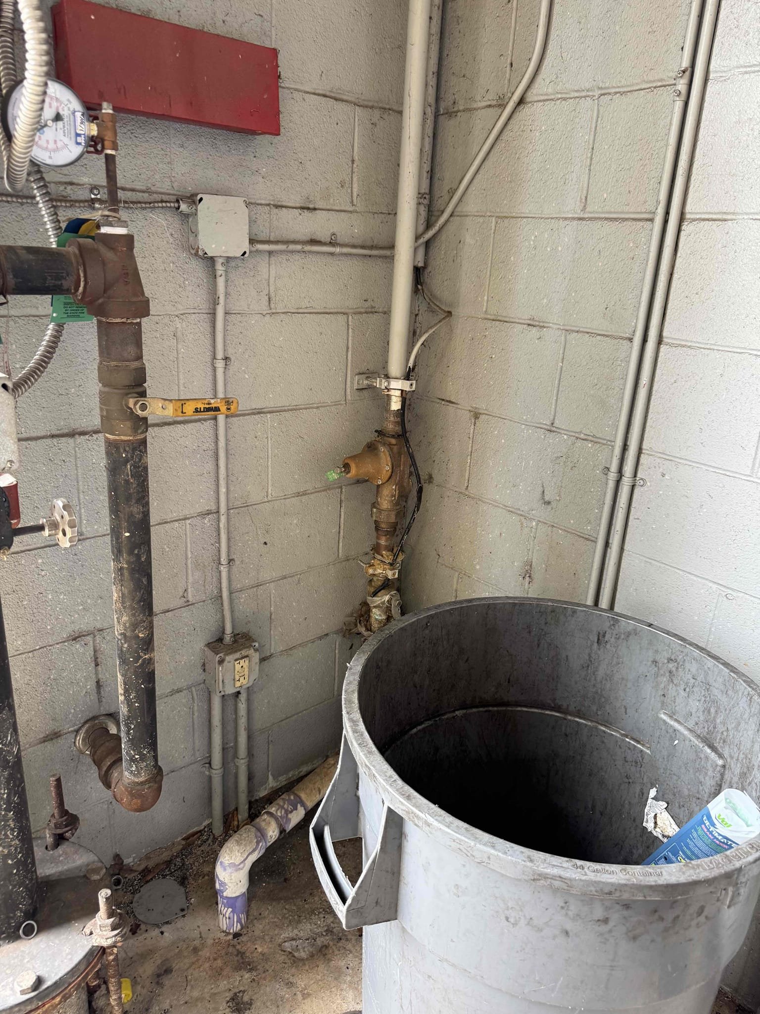 Upon inspection, a water leak was identified originating from the main water line. The leak was located halfway down the parking lot, where water was seeping through the asphalt. The 2” PVC pipe, extending 225 feet from the meter to the pressure-reducing valve (PRV), was inspected. The clean-out was found ten feet from the leak. The irrigation system was confirmed to be off, as per the manager. The water line to the irrigation was also checked and found to be disconnected. The 2” PVC pipe emerged from the ground, connecting to a 1 1/2” Watts PRV. Water supply to the store had been turned off for three days.