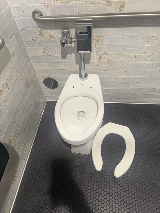 On 7/17/26, I addressed an issue with the men's restroom toilet seat, which lacked bolts for proper attachment. I removed the broken seat and installed a commercial-grade open-end oblong toilet seat, ensuring a secure and functional replacement. The new seat was carefully fitted and tested for stability and comfort.