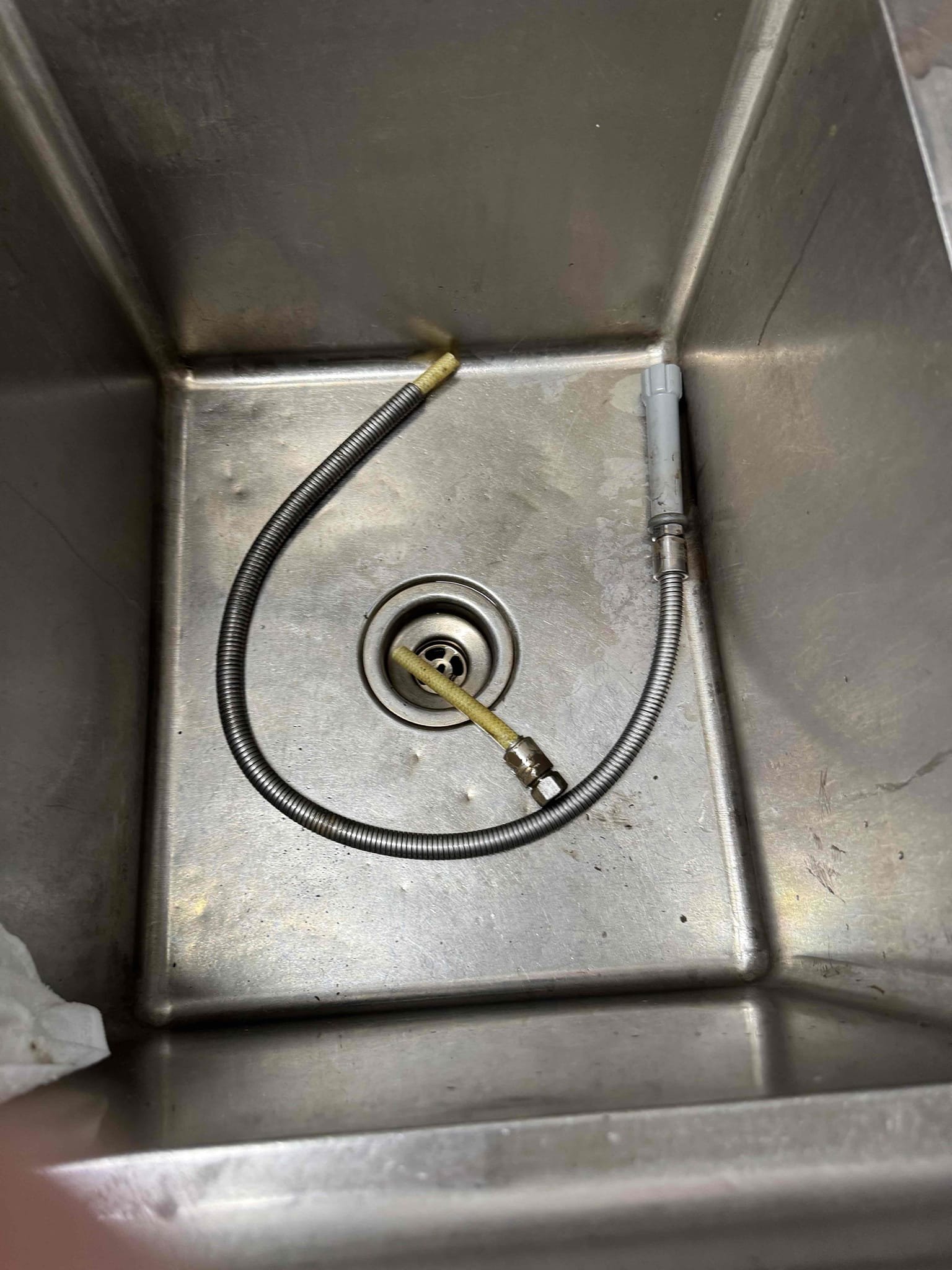 Upon identifying a break in the metal casing of the SS flex hose, I promptly sourced a replacement. I removed the old sprayer and hose, then extracted the spring. A new T&S SS flex hose was installed into the existing spring. After resetting the sprayer, I conducted thorough testing to ensure functionality. Throughout the process, I was supervised by Manager Judith. The replacement parts used included a T&S SS flex hose measuring 44 inches.