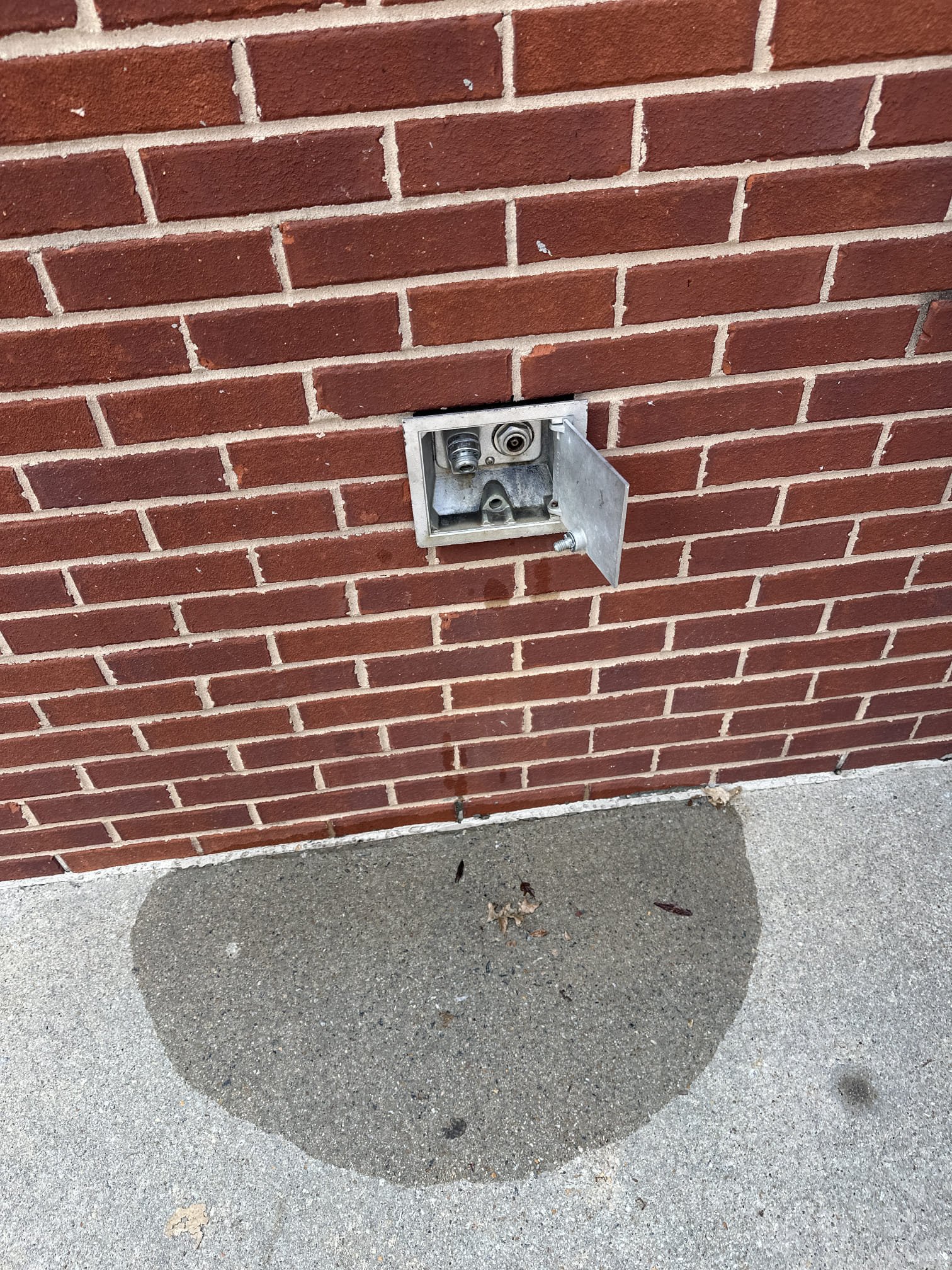 Upon arrival, I inspected the wall hydrant by the patio door, which had a slow trickle and appeared to be pushed out by an inch. Using a church key, I shut the hydrant off completely, stopping the leak. I then inspected the area behind the refrigerator, discovering a recent wall repair that had pushed out the hydrant. To secure the water line, I removed the wall repair, blocked the drive-thru, and straightened the bent brace arm. I installed new wood braces, secured the hydrant, reset the wall, and sealed it with silicone. Although I couldn't set the alarm, I locked the doors.