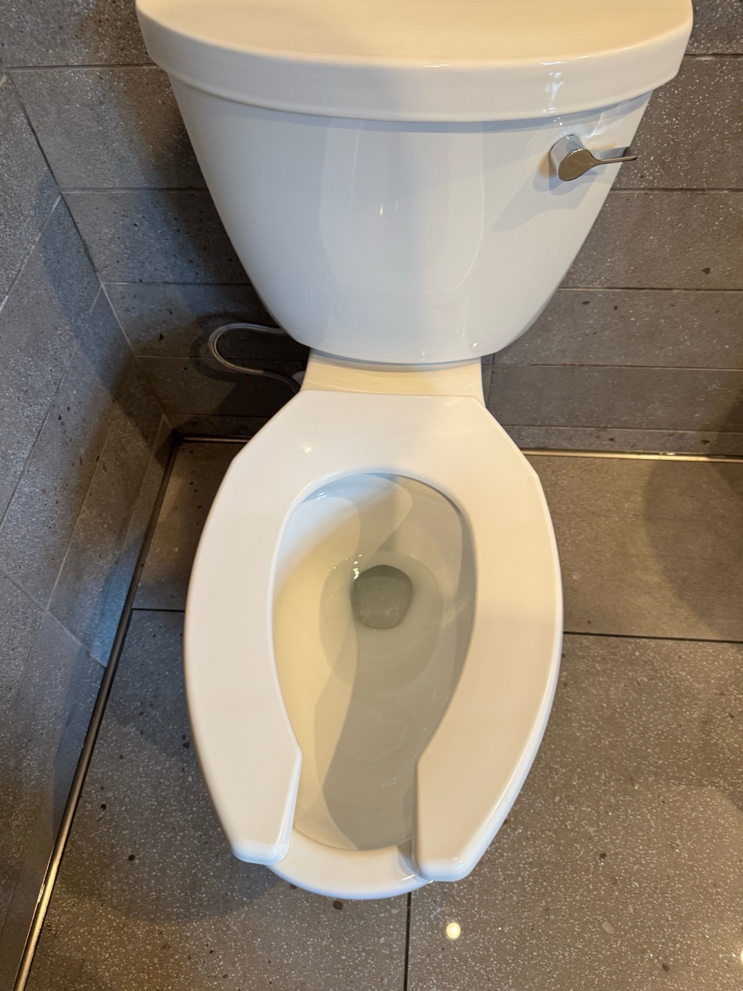 This morning, a toilet overflowed into the cafe area. Upon inspection, I confirmed that the toilet was flushing properly. To address the issue, I adjusted the fill valve on the toilet to ensure it operates correctly. I coordinated with the hazmat team to clean the affected bathrooms and cafe. The team is currently on-site, handling the cleanup. I signed off the job as completed.