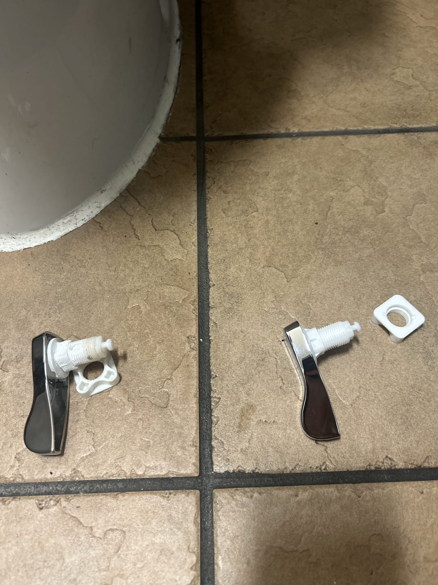 Upon arrival, we documented the water heater with a photo of its rating plate. We then inspected the pressure-assist toilet in the right bathroom, identifying a broken handle that was causing it to constantly run and fail to pressurize. We removed the faulty handle and installed a new one. After installation, we tested the toilet multiple times to ensure it functioned correctly. The part used was a Flush Handle for pressure assist. The issue was resolved, and the toilet operated without any further problems.