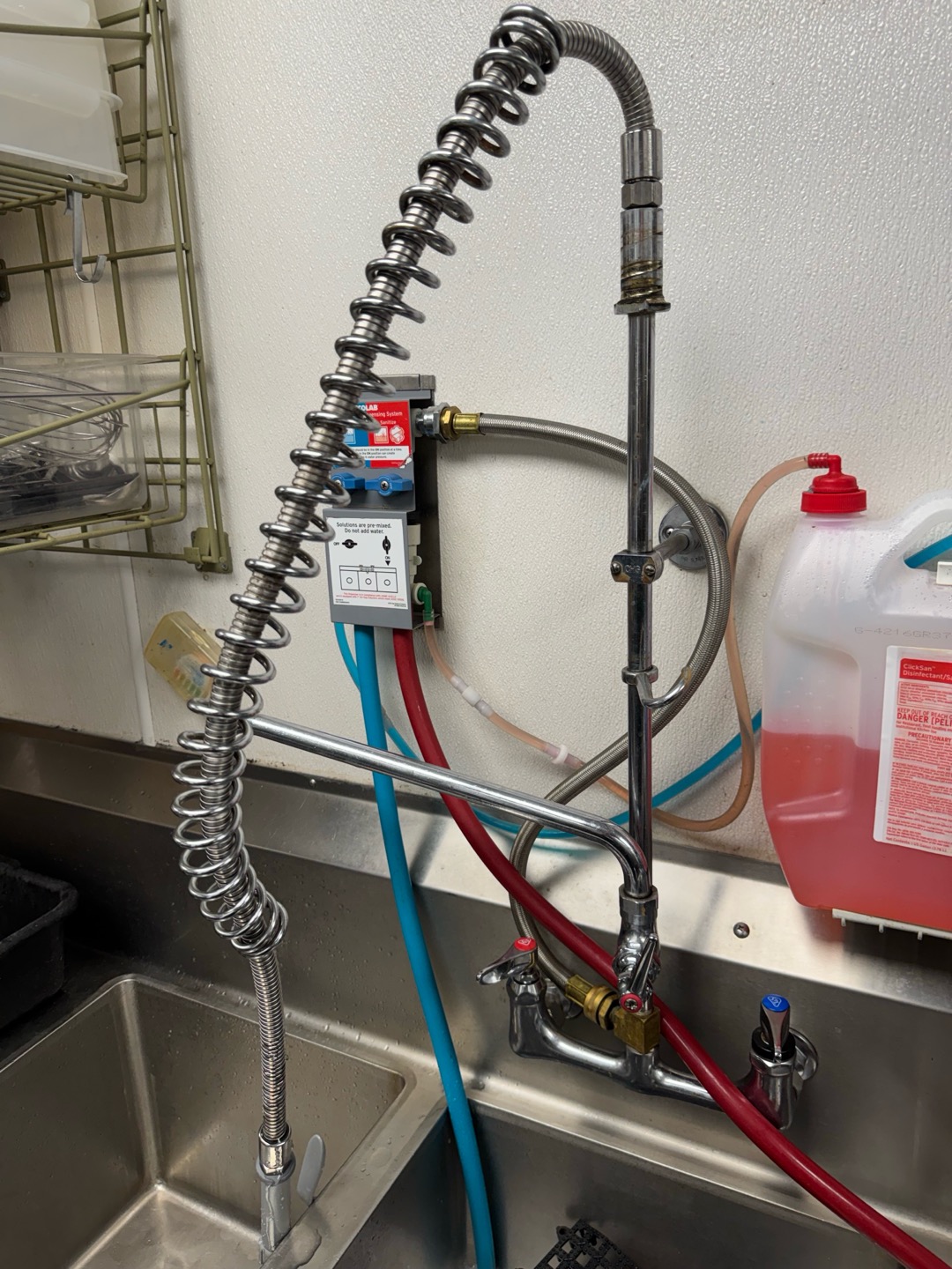 Upon inspection, I identified a leak originating from the hose connected to the composite sink faucet. The issue was traced to a broken spring within the faucet mechanism, which was responsible for securing the hose. I promptly replaced the faulty spring and the leaking hose. After installation, I conducted a thorough test to ensure there were no further leaks. The job was completed to the satisfaction of the client, who signed off on the work. Parts used included one TNS spring for the pre-rinse and one TNS sprayer hose.