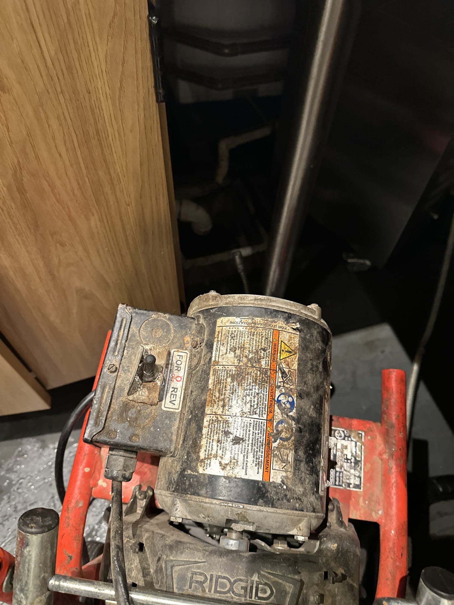 Upon arrival, I inspected the floor sink under the hand-off counter, which was clogged and holding water. I began by using a small auger to attempt to dislodge the clog, but it was too deep. Next, I employed a small machine to reach the blockage, which was located approximately 25 feet down. After successfully hitting the clog, I pushed the cable all the way out and then pulled it back. To ensure the clog was completely removed, I flushed the sink with several buckets of hot water, which flowed freely without any issues. The floor sink is now clear and functioning properly.
