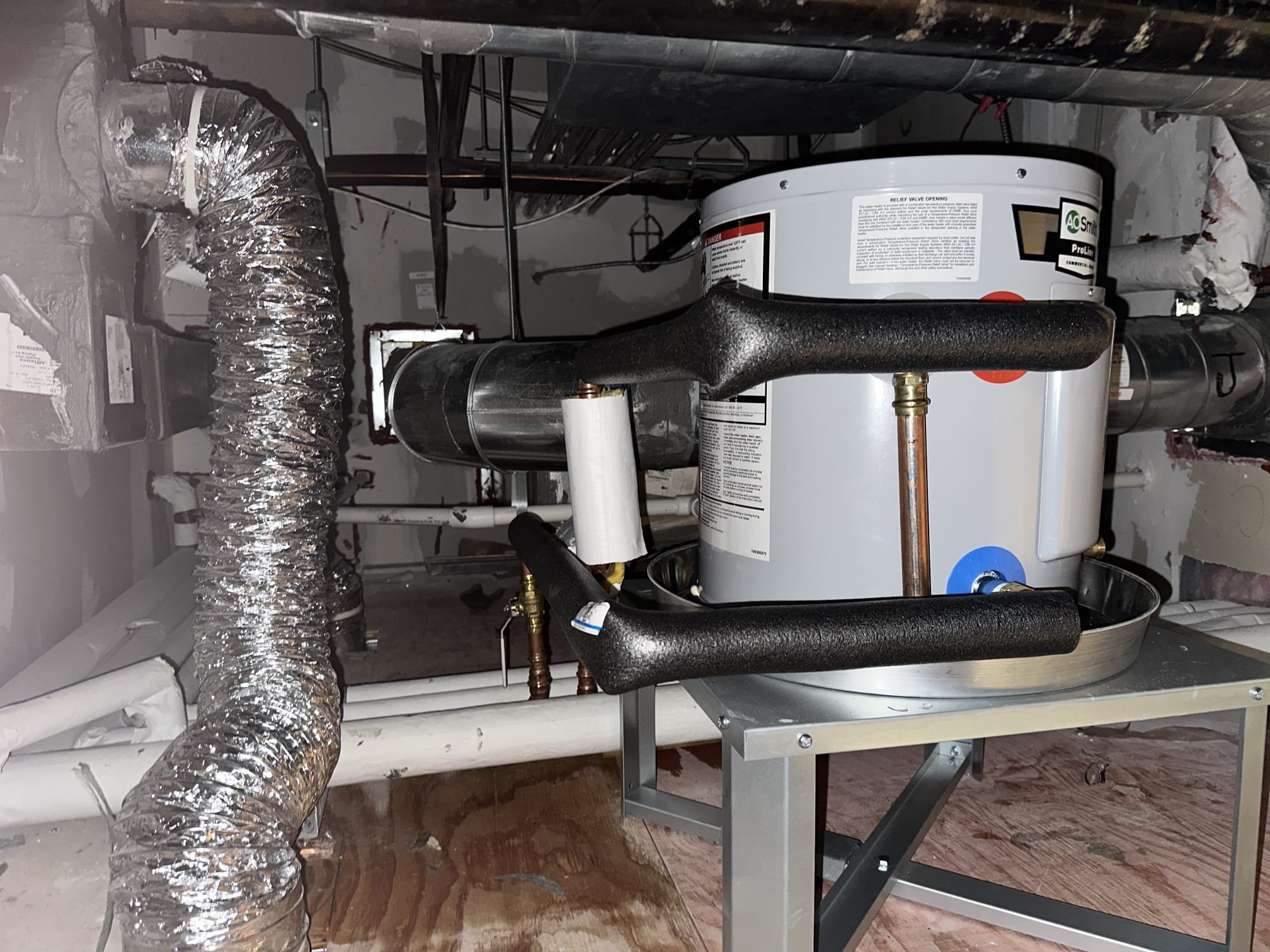 Upon arrival, I identified a suitable spot for the new 10-gallon heater above the men’s bathroom. I installed the heater on a custom-modified stand to ensure proper water drainage. I connected the necessary copper and PVC piping, including 3/4” FIP and MIP copper pipes, ball valves, and bushings. I checked for leaks and found none. The heater is currently without power, pending the installation of an outlet. All parts were used as specified.