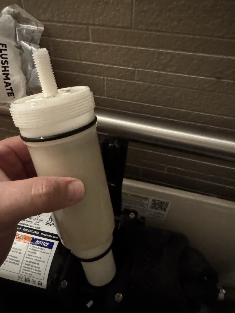Upon inspection, the pressure assist toilet in the first bathroom to the left was not functioning correctly. After identifying the issue as a faulty cartridge, I replaced it with a new Sloan pressure assist cartridge. This resolved the flushing problem, ensuring the toilet operates smoothly. The replacement was completed efficiently, and I confirmed the successful repair by testing the flush. The homeowner, Sean, signed off on the completed work.