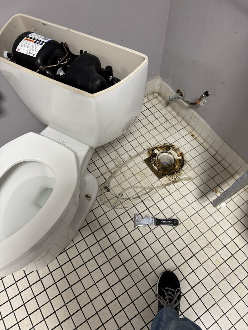Upon inspection, I discovered water leakage near the toilet. I turned on the water and flushed, observing water seeping from the back at the base. I removed the toilet, cleaned the old silicone from the floor and base, and scraped away the deteriorated wax ring. A new wax ring was installed, and the toilet was reset using four new plastic shims with the existing closet bolts. I reconnected the supply line, turned on the water supply, and tested the toilet. Finally, I sealed around the base with clear silicone. Manager Gail was present during the work. Parts used included a wax ring, four plastic shims, and clear silicone.