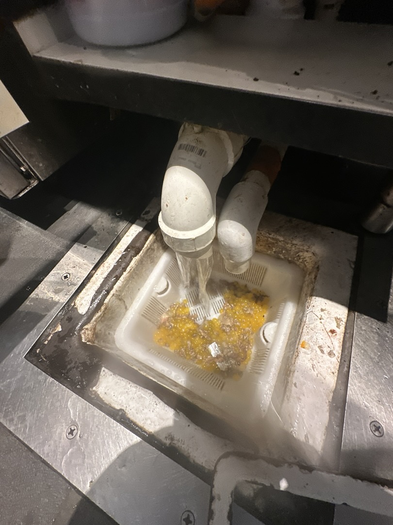 Upon arrival, I conducted a thorough inspection of the dump sink located at the cold bar. The sink was exhibiting signs of a clog, with water draining slowly. To address the issue, I employed a small auger to break up any obstructions within the drain. Simultaneously, I used hot water to help dissolve any buildup. After successfully clearing the clog, I flushed the sink with hot water for several minutes to ensure the drain was completely clear. The sink is now functioning properly, with water draining efficiently. The clog has been resolved, and the sink is back to its optimal condition.