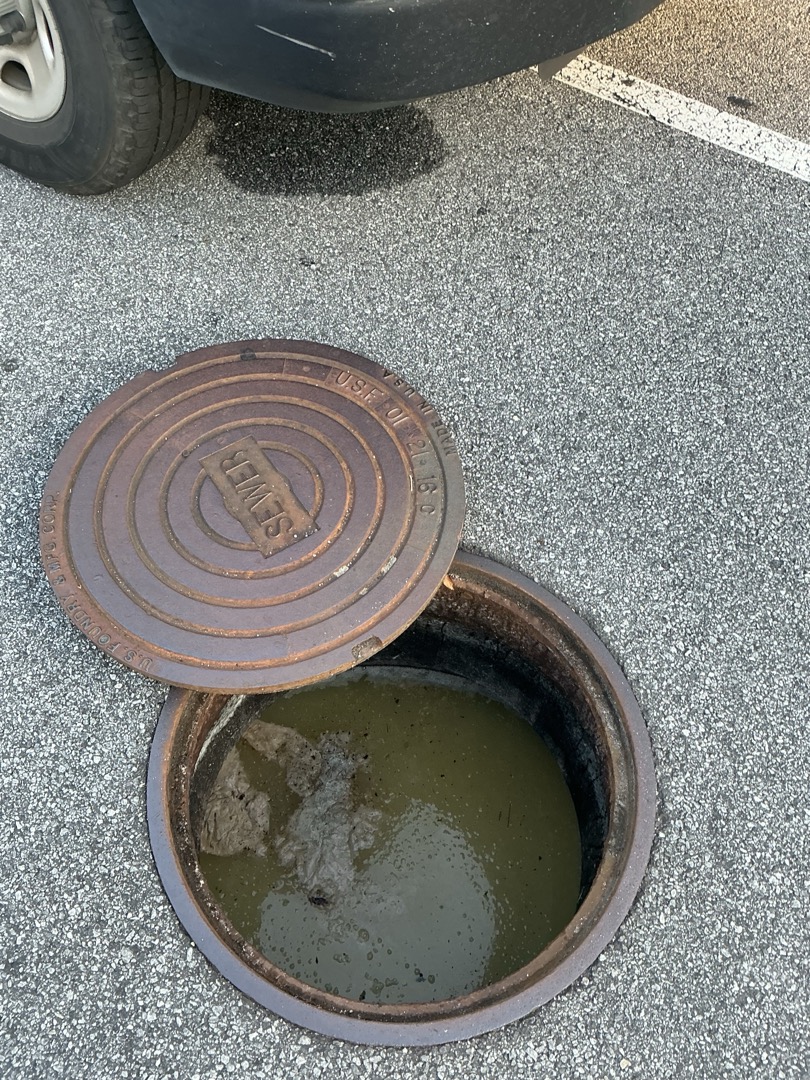 I responded to two calls, one of which was an emergency jetting service. Upon arrival, the main drain was experiencing significant backup. I first removed the test port lid and discovered it was full, with the clog located after the test port. I used the drain machine in the cleanout after the test port to clear the clog. After successfully unclogging the drain, I flushed the toilets in both restrooms, which now flushed properly without any floor drains backing up. Later, I ran the jetter in the test station, pushed the camera until it met the main sewer tee, and recorded and inspected the pipe. A significant clog was found where the restrooms tee into the side of the line. I cleared the clog and ran the jetter from the cleanout at the building edge, followed by another camera inspection to ensure everything was clear.