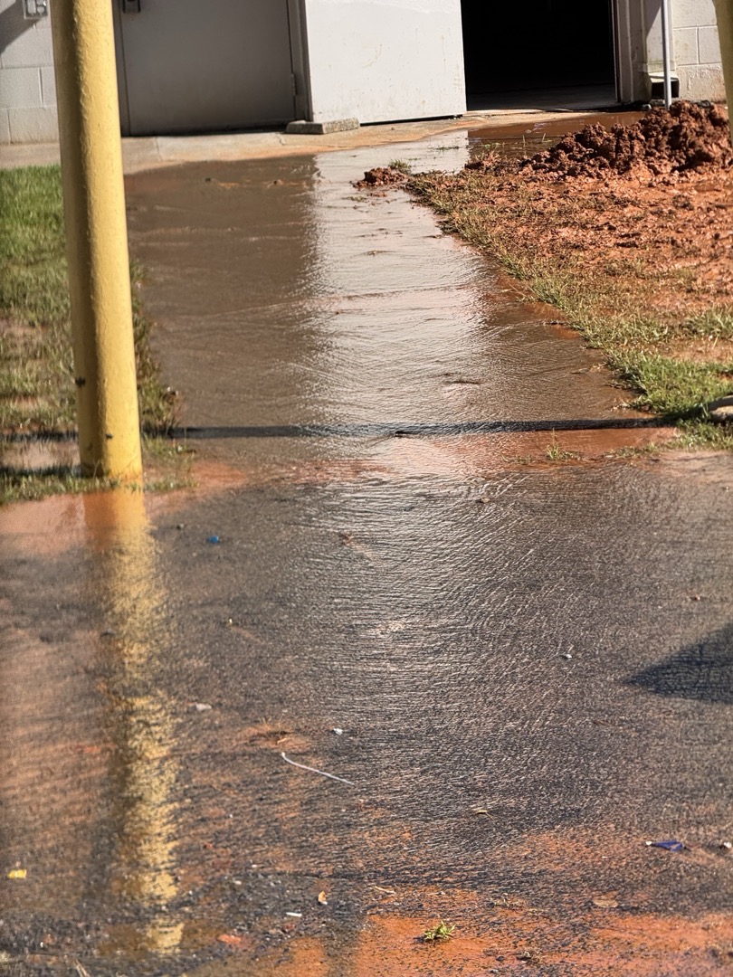 Upon arrival, I assessed the low water pressure issue. Investigating further, I discovered that the problem extended to the entire complex. After inspecting the area, I identified a burst main water line caused by ongoing construction in a nearby unit. I informed the manager, Micheal, and provided photographic evidence. I signed for Micheal to avoid any contact with my phone.