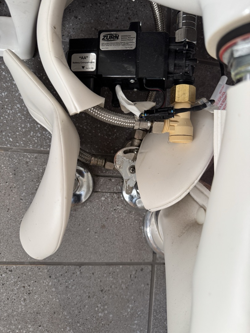Upon arrival, I identified that the Zurn sensor faucets were experiencing constant on-off cycling in both bathrooms. After thorough inspection, I discovered the Hydro-X Power hydrogenerator was improperly installed. Removing this component resolved the issue, and the faucets are now functioning correctly. This installation method is not standard for regular battery-operated faucets. The job was completed efficiently, ensuring the system operates as intended.