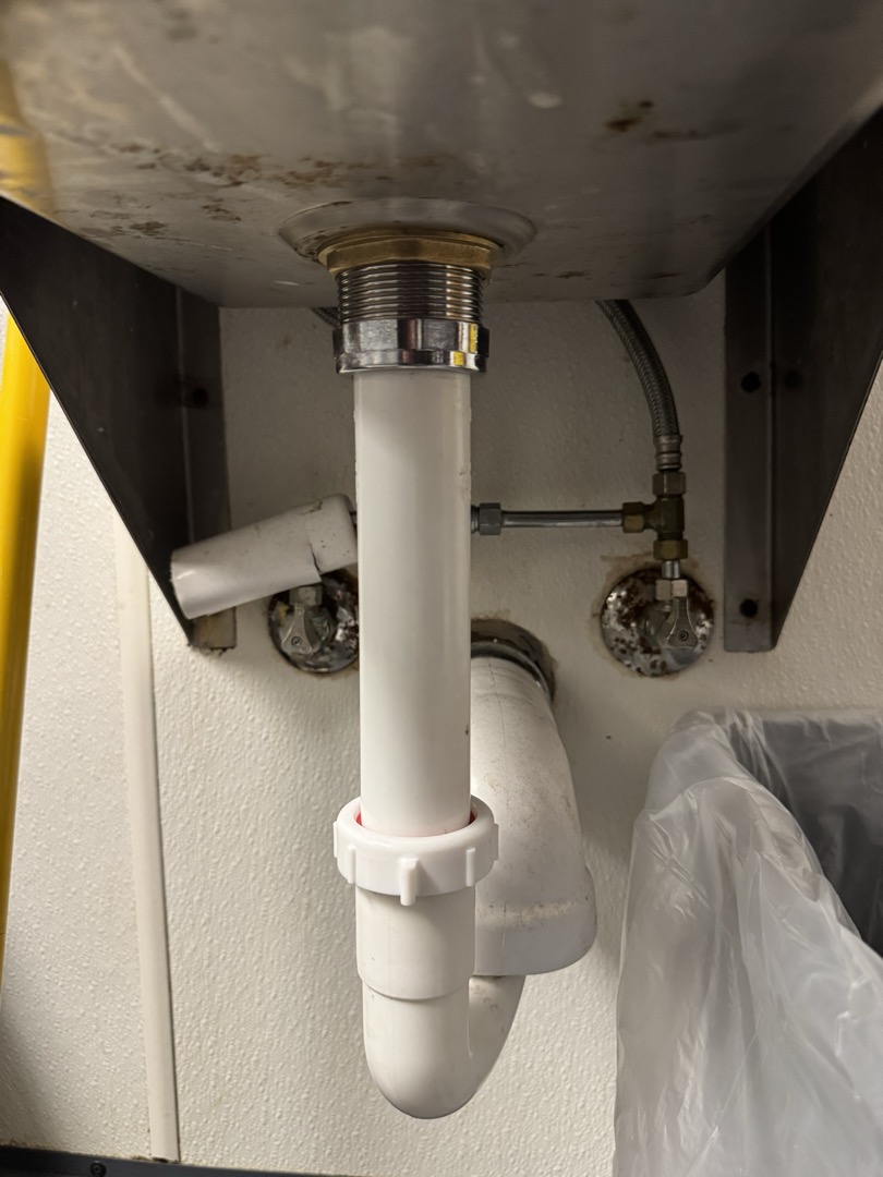 Upon inspection, I identified a leak originating from the sink strainer. I carefully removed the old strainer, ensuring no damage to the surrounding fixtures. A new junior basket strainer was then installed, followed by the reset of the tailpiece using a fresh 1-1/2” plastic lock ring. After completing the installation, I conducted thorough testing to confirm the absence of any leaks. The job was performed under the supervision of Manager Danielle, who was present on site. All parts used were accounted for and properly installed.