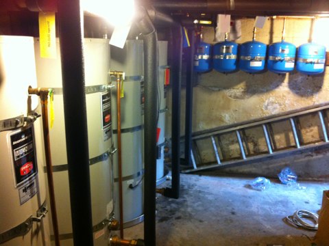Wow! Here is the finished installation of five 120 gallon Bradford White storage tanks working with seven existing solar panels and one boiler that supply this Oakland apartment building. Apart from their clean, professional work with the tanks, Tony and Enrique did an excellent job rerouting and repiping the water lines to better suite the flow of the recirculating line and improve overall efficiency. Wow! Here is the finished installation of five 120 gallon Bradford White storage tanks working with seven existing solar panels and one boiler that supply this Oakland apartment building. Apart from their clean, professional work with the tanks, Tony and Enrique did an excellent job rerouting and repiping the water lines to better suite the flow of the recirculating line and improve overall efficiency.