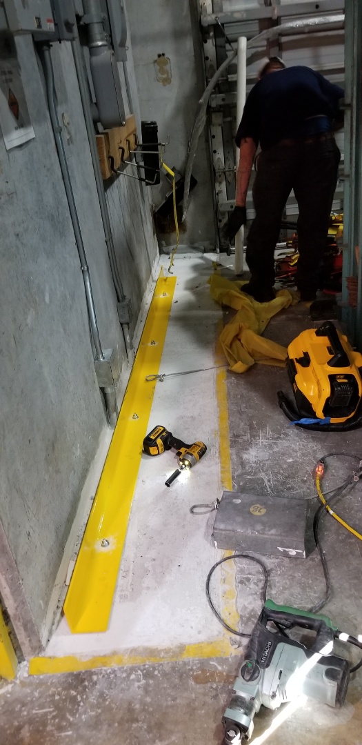 Medley, FL - Installing angle iron to protect electrical boxes from being hit by forklift Medley, FL - Installing angle iron to protect electrical boxes from being hit by forklift