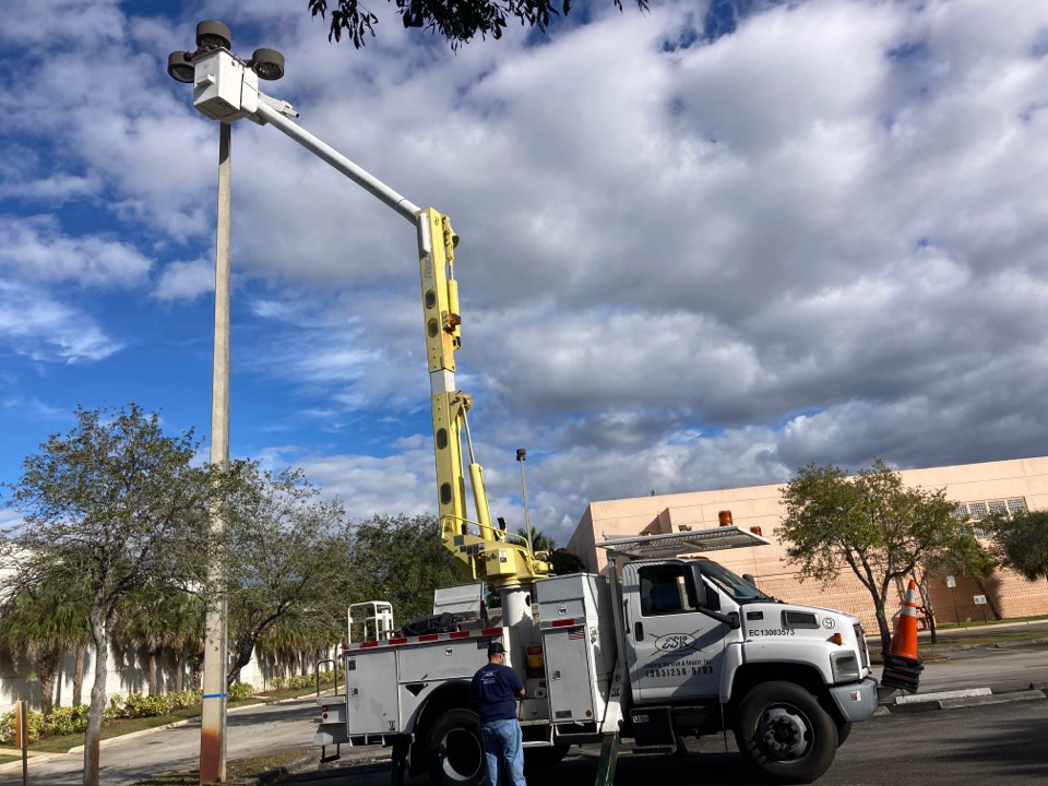 Installing new parking lot lighting replacing lamps and ballast kits.  Local Electrician near Pembroke Pines, FL.