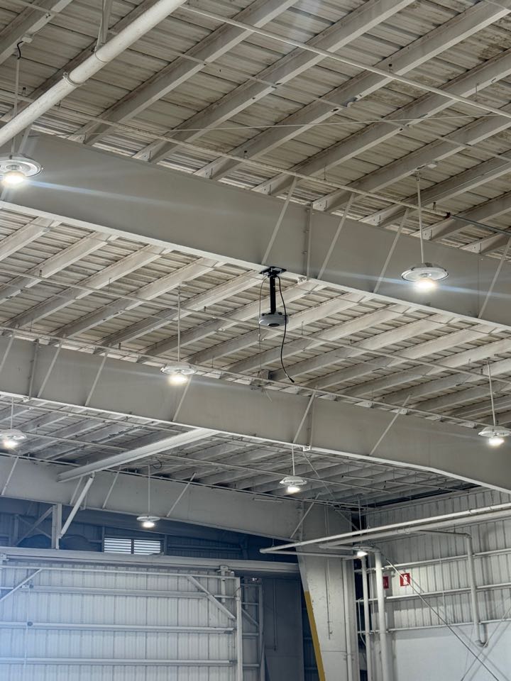 Installing industrial fan at airplane hanger 