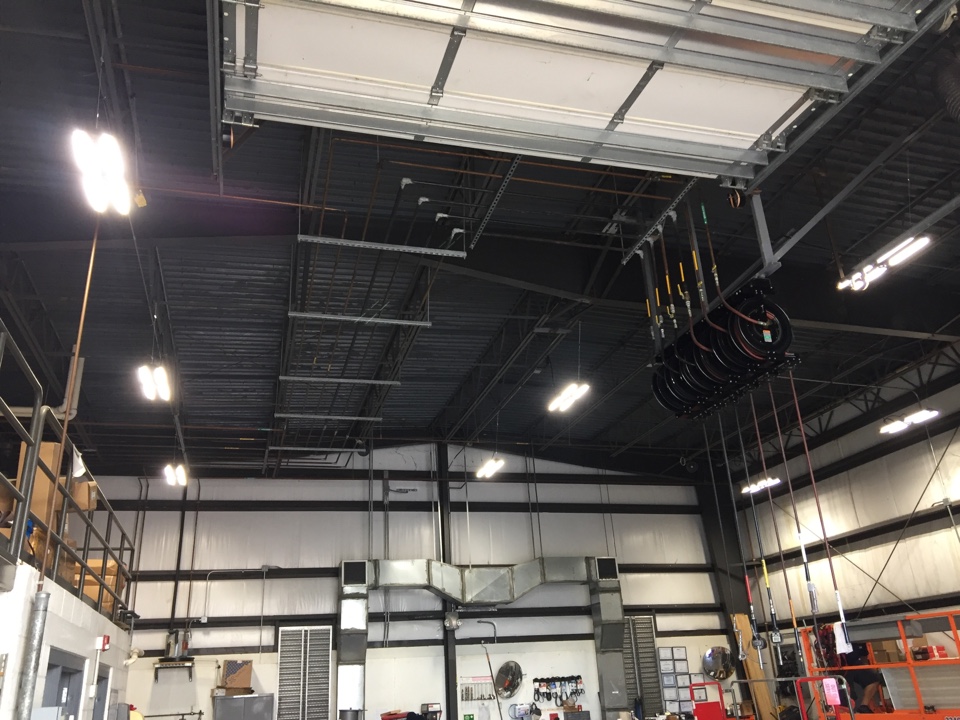 Local commercial electrician in Riviera Beach providing light fixture replacements for LED lights at mechanic's shop. Auto mechanics can finally see while working on vehicles; increasing productivity and safety. 