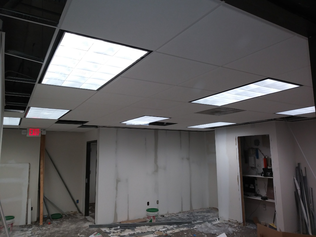 Install 2x4 layin light fixtures. Also change exits lights through out space. 