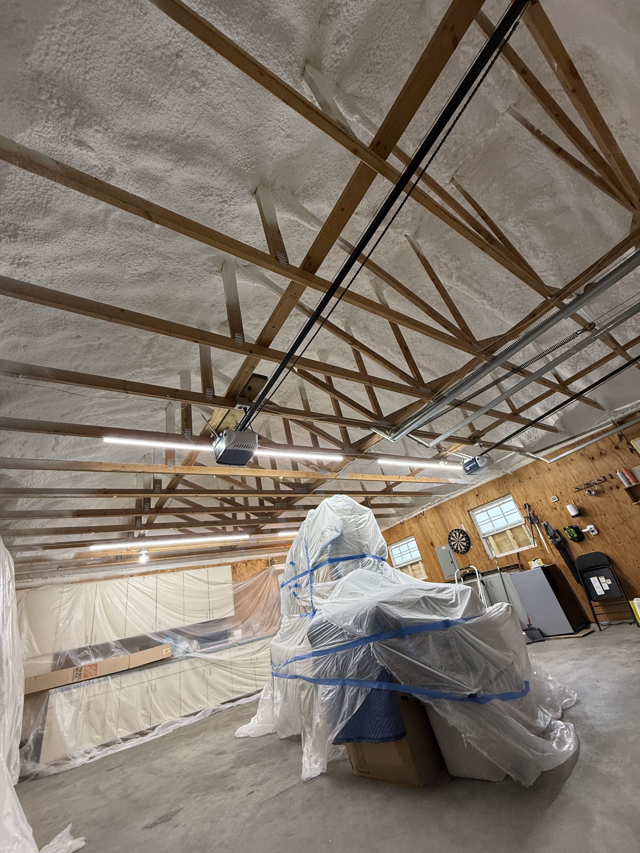Kansas City, Kansas customer work shop garage was uncomfortable to work in so they asked for a solution. We came in with 8 inches of open cell and a fire proof retardant paint.