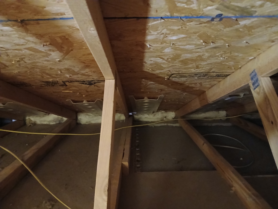 Baffling and blocking perimeter to prevent new cellulose from falling onto the soffits