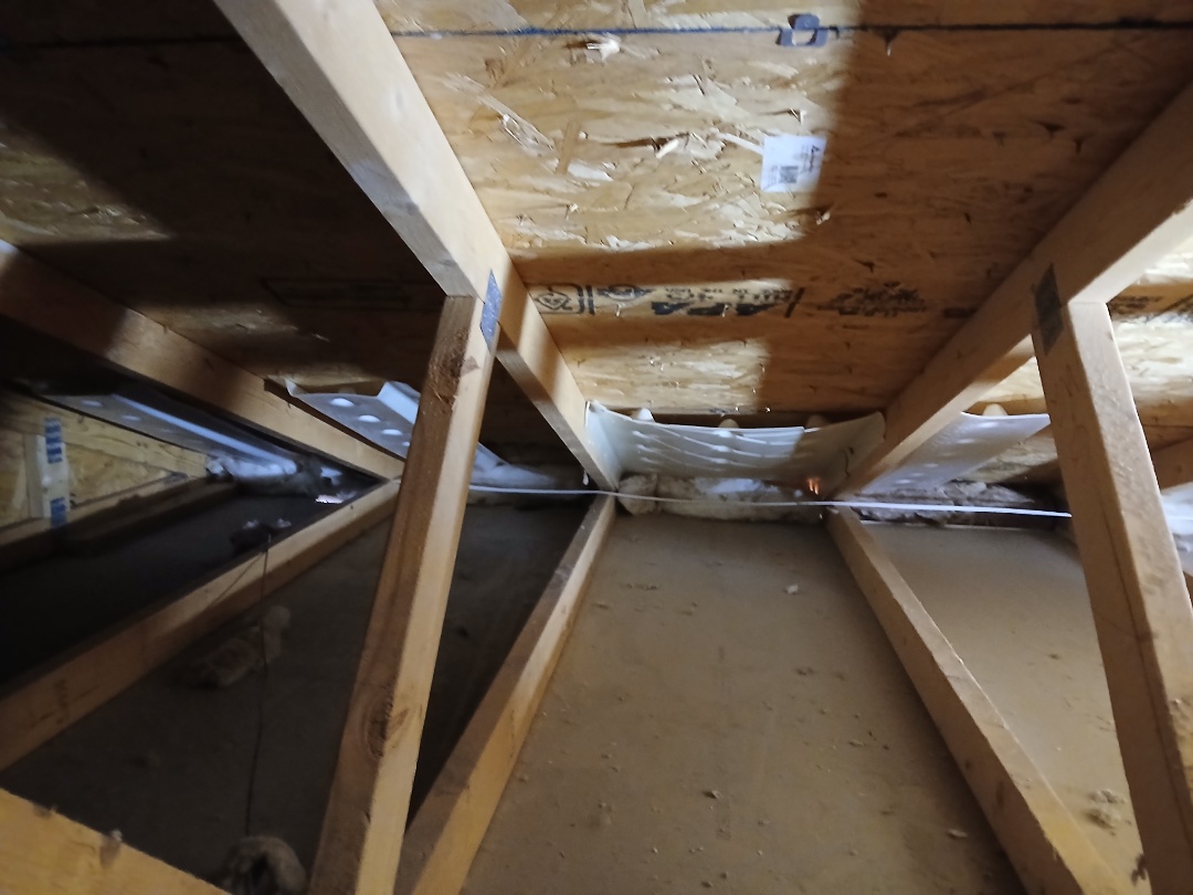 Baffling and blocking perimeter to prevent new cellulose from falling onto the soffits