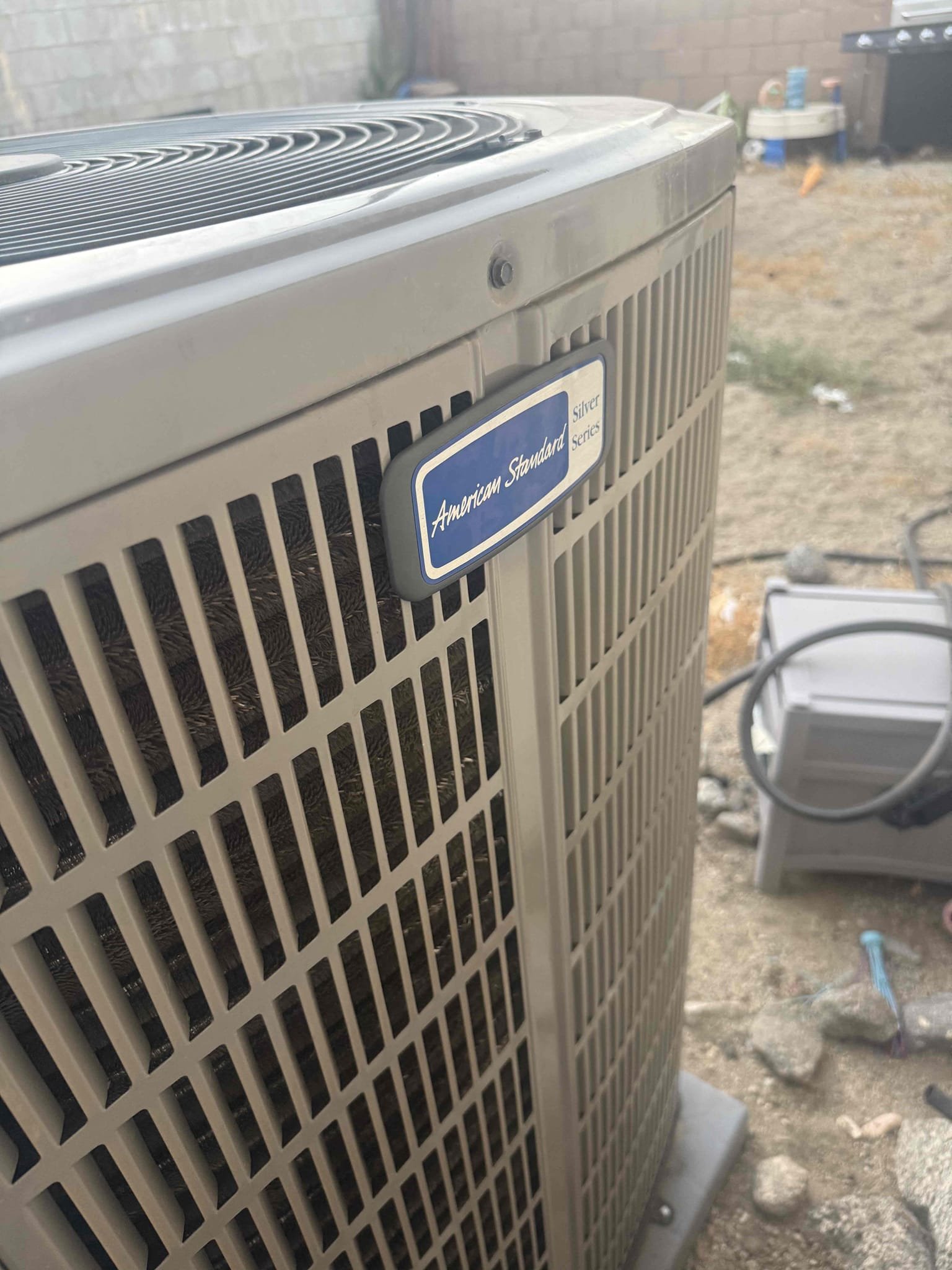 La Quinta, CA - Condenser outdoor unit was very loud and checked all vital readings. Refrigerant is to unit specifications. Motor amps and voltages fine. Found American Standard nameplate was vibrating so loud it sounded like an old compressor. Moved to opposite side and verified all screws are tight and condenser top with condenser fan motor were aligned and no more noise issue. They could hear it loudly in their main bedroom. Went with tenant to room while system running and she said it sounds normal now. No issue with system cooling.