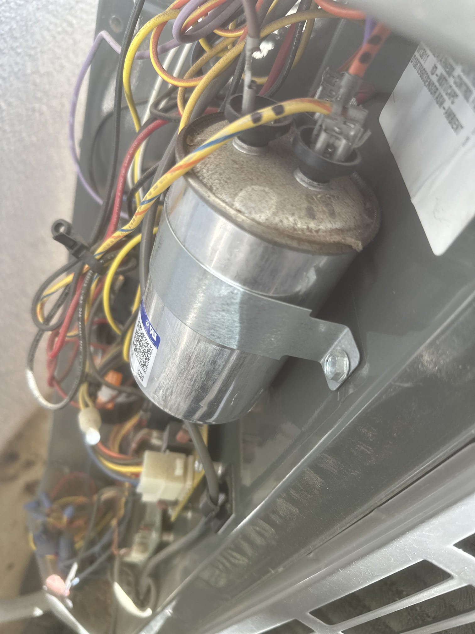 Demand Service Call – No Cooling
Equipment: American Standard Gold – 4 Ton
Model: 4A6H7048A1000B
Serial Number: 21302LWVN1F
Manufacture Date: July 2021
Upon arrival, found the indoor equipment operating but the outdoor equipment was not cooling properly. Further inspection revealed a swollen and leaking 35/7.5 MFD dual-run capacitor.
Replaced the defective capacitor with a new 35/7.5 MFD capacitor. Cycled the equipment and verified proper operation of the compressor and condenser fan motor. Tested compressor starting amperage (inrush) and verified compressor and condenser fan motor running amperages.
The thermostat was reading 83°F upon arrival and decreased to 78°F upon completion of service.
System Status: Equipment is now cooling and operating properly.