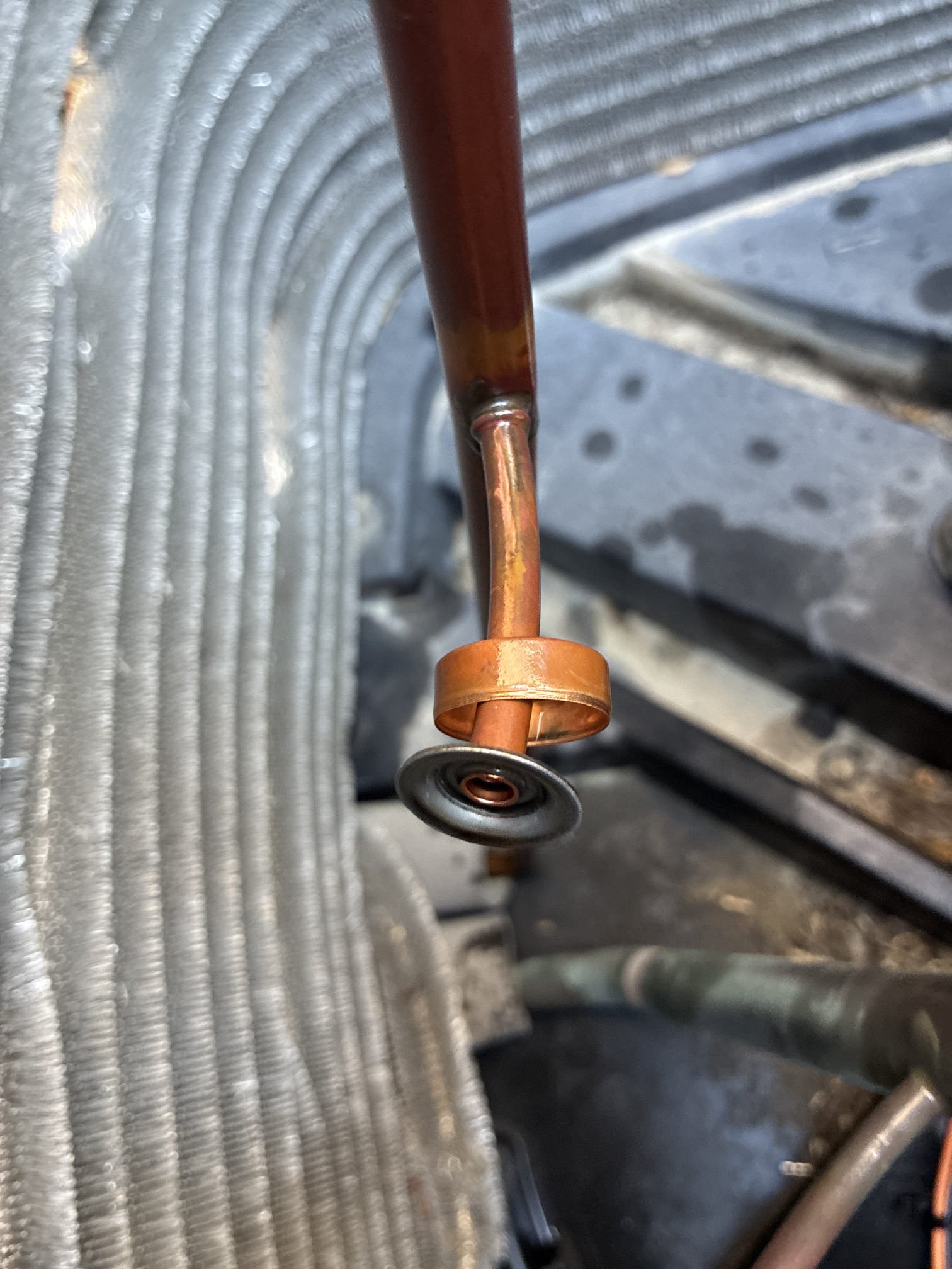 Upon arrival client stated system stopped cooling. Found copper pressure switch busted open and refrigerant leaked out. Went over function of pressure switch. Cut out switch and brassed copper closed. Pressurized system and pulled deep vacuum. Recharge system and checked temperature split.