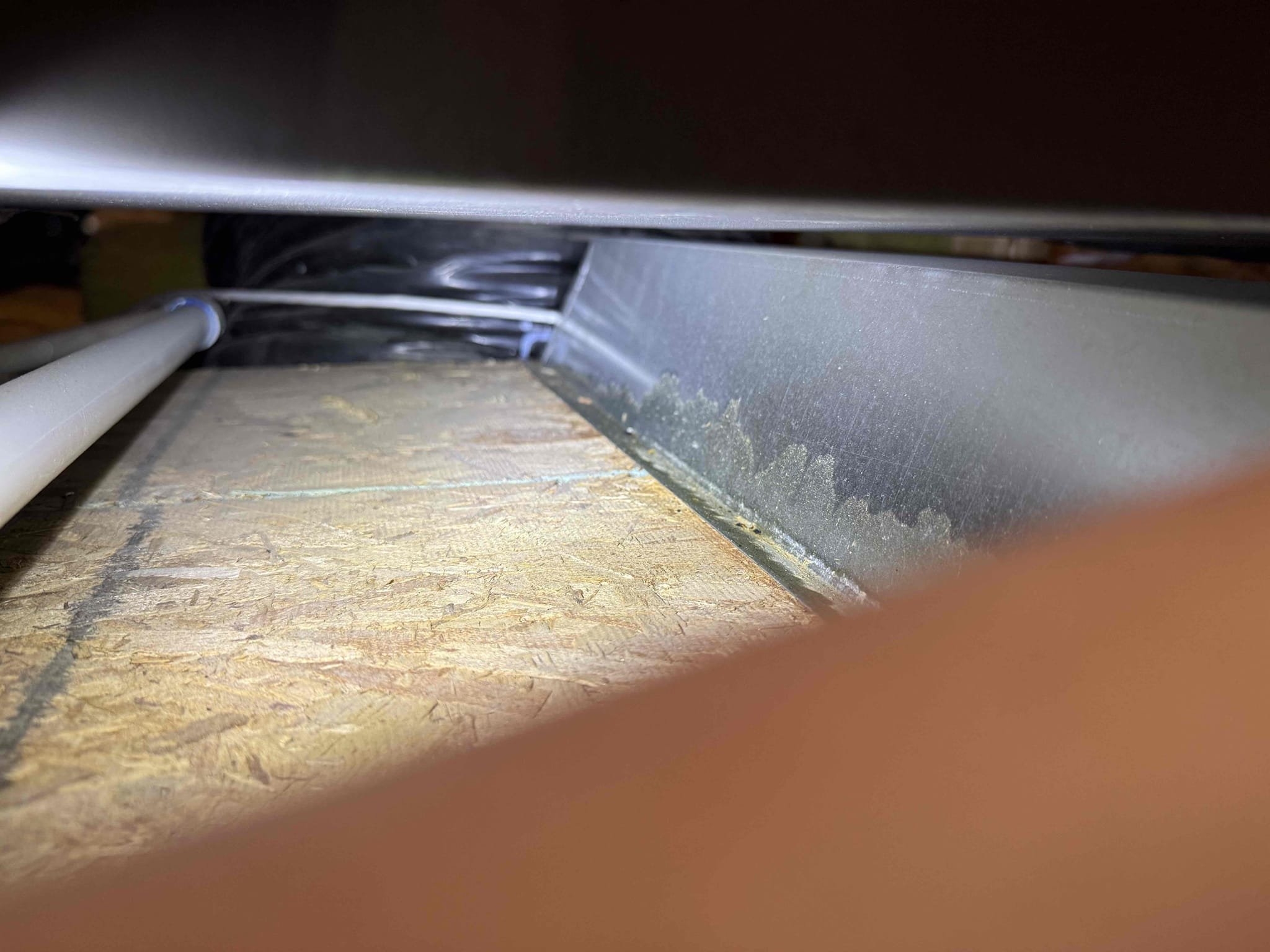 Homeowner noticed water dripping from ceiling return right before main bedroom door when it rained recently. He then noticed from looking at roof outside that the flue pipe was showing about 2 feet of unpainted sheet metal section. Top half with slanted cover painted a brownish red and had concern if we had moved it during maintenance or demand. Flu was no longer used as system was previously a gas furnace and a company replaced with a heat pump. I was able to pull it down til no more exposed sheet metal section was visible from street. I showed homeowner pictures from when I was in attic and vent was always like it was today upon arrival. Recommended maybe reaching out to a contractor about how it should be to prevent any rain coming in.