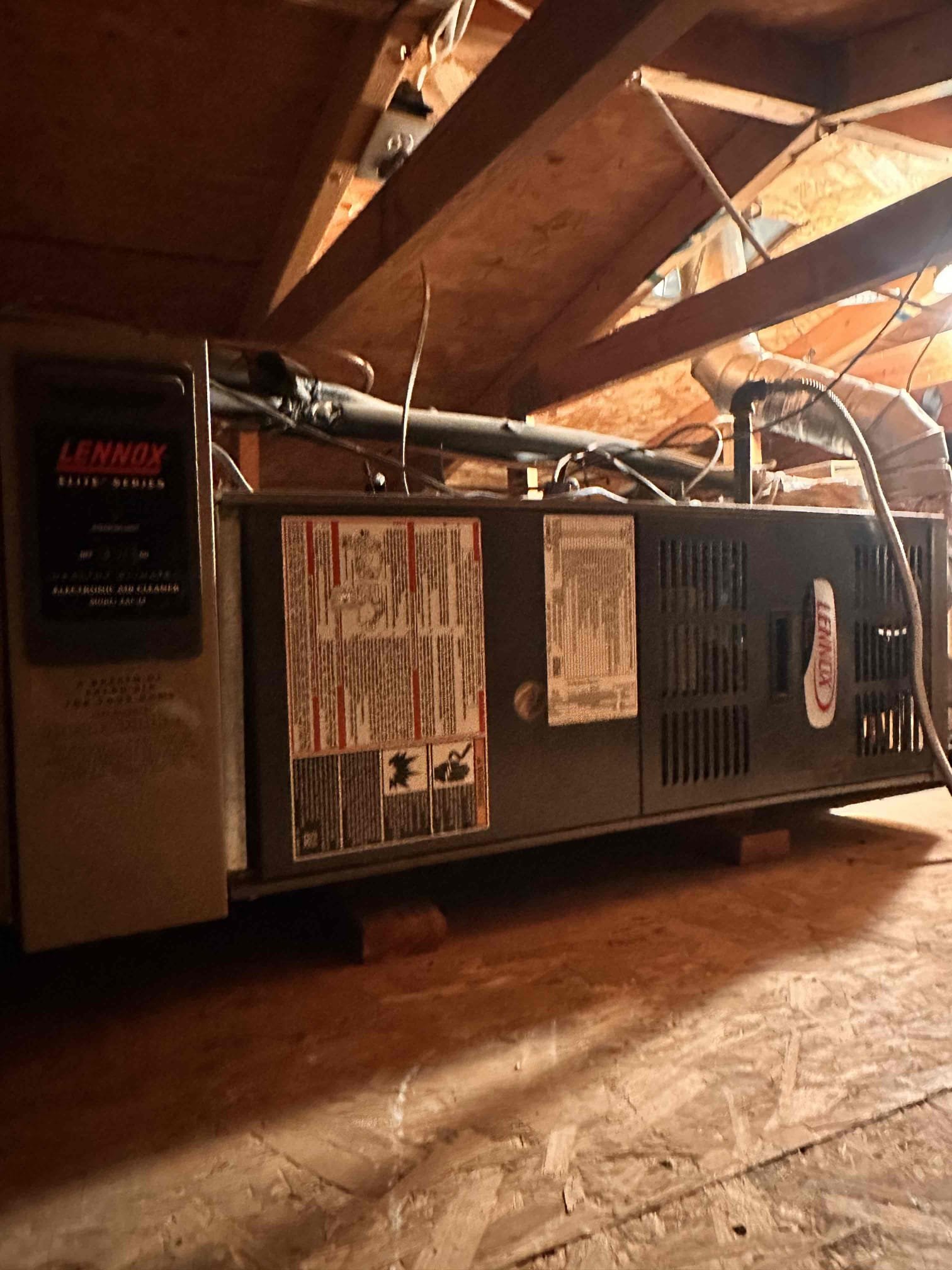 Performed scheduled indoor equipment maintenance and safety checks on two natural gas heating systems located in the attic, with hallway access next to the garage entrance. Accessible equipment identified as 2009 Lennox, model G60UHV-36A-070X-09, serial 5909A13860. The second system’s data plate and burner compartment were inaccessible due to excessively tight attic clearance, limiting inspection of that equipment.

Replaced one 20 × 30 and two 14 × 24 filters located in ceiling returns. Cleared equipment platforms of dust and debris. Verified ductwork was secured and attached to both systems and in fair condition. Cleared condensate lines; outside terminations are next to the outdoor equipment on the east end of the home. Verified both Honeywell 6000 thermostats were operational.

Verified heating temperature rise on both systems and checked temperatures at multiple registers throughout the home. Documented Lennox return temperature at 80.4°F and supply temperature at 124.0°F, providi