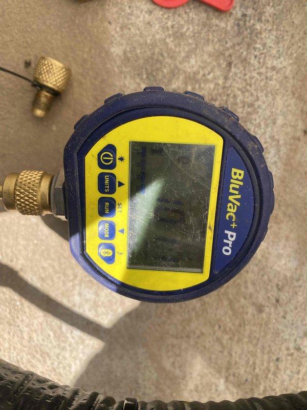 Responded to service call at customer residence during 6-7 window as requested, contacting wife per instructions. Performed refrigerant pressure testing using Bluevac Pro digital gauge to verify system charge levels. Inspected condensate drainage system and repaired PVC condensate line with multiple joints showing signs of previous leakage near Bosch equipment. Proper tools utilized to ensure watertight connections and prevent future moisture issues.