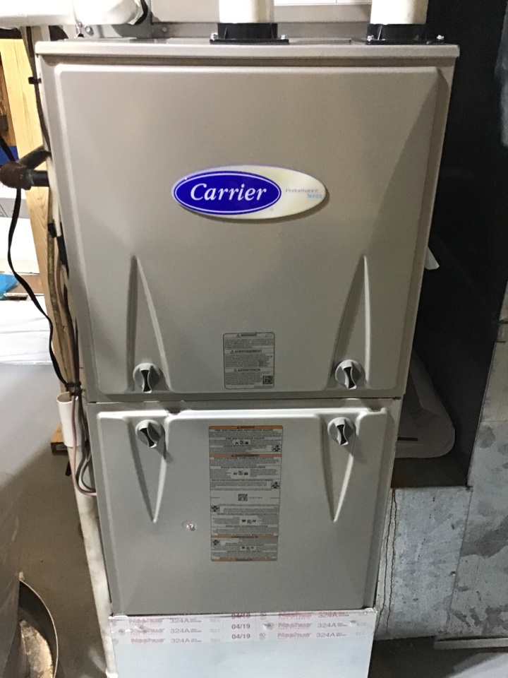 Performing a preventative maintenance tune up on a carrier furnace for Mr.Hoelscher. 