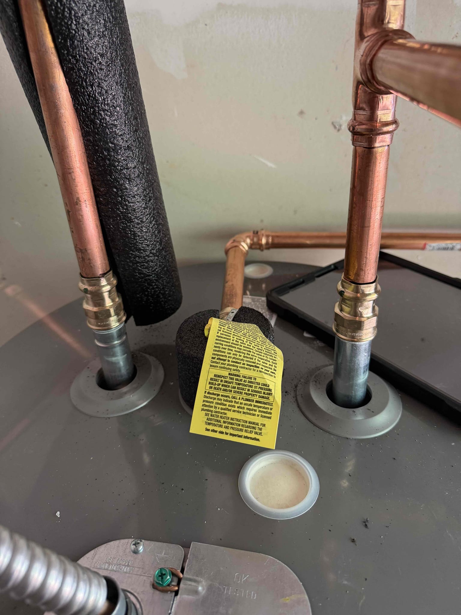 Homeowner states that she noticed the shower after would sometimes get hot and other times tepid. She called us to see if the issue was fixable without changing the EWH. Upon arrival homeowner greeted me and showed me the EWH located in backyard and it is 14+ years old. I explained and recommended replacing due to its age and high water pressure which she agreed to and I stated by draining the EWH. Once It was drained I cut off the pipe and installed CPVC to copper adapters and also removed the PRV with the main shut off and installed CPVC to PEX adapters. I then put the new EWH together with the extended warranty and stickers and brought to the new install place and placed the drip pan first. Once in place I then installed the new shut off and PRV with pex pipe and crimped it together using copper rings. Then I pressed the new pipe connecting the EWH and then I waited for the glue to cure. Once enough time passed for the glue to cure I turned on the meter and turned on the main shut o