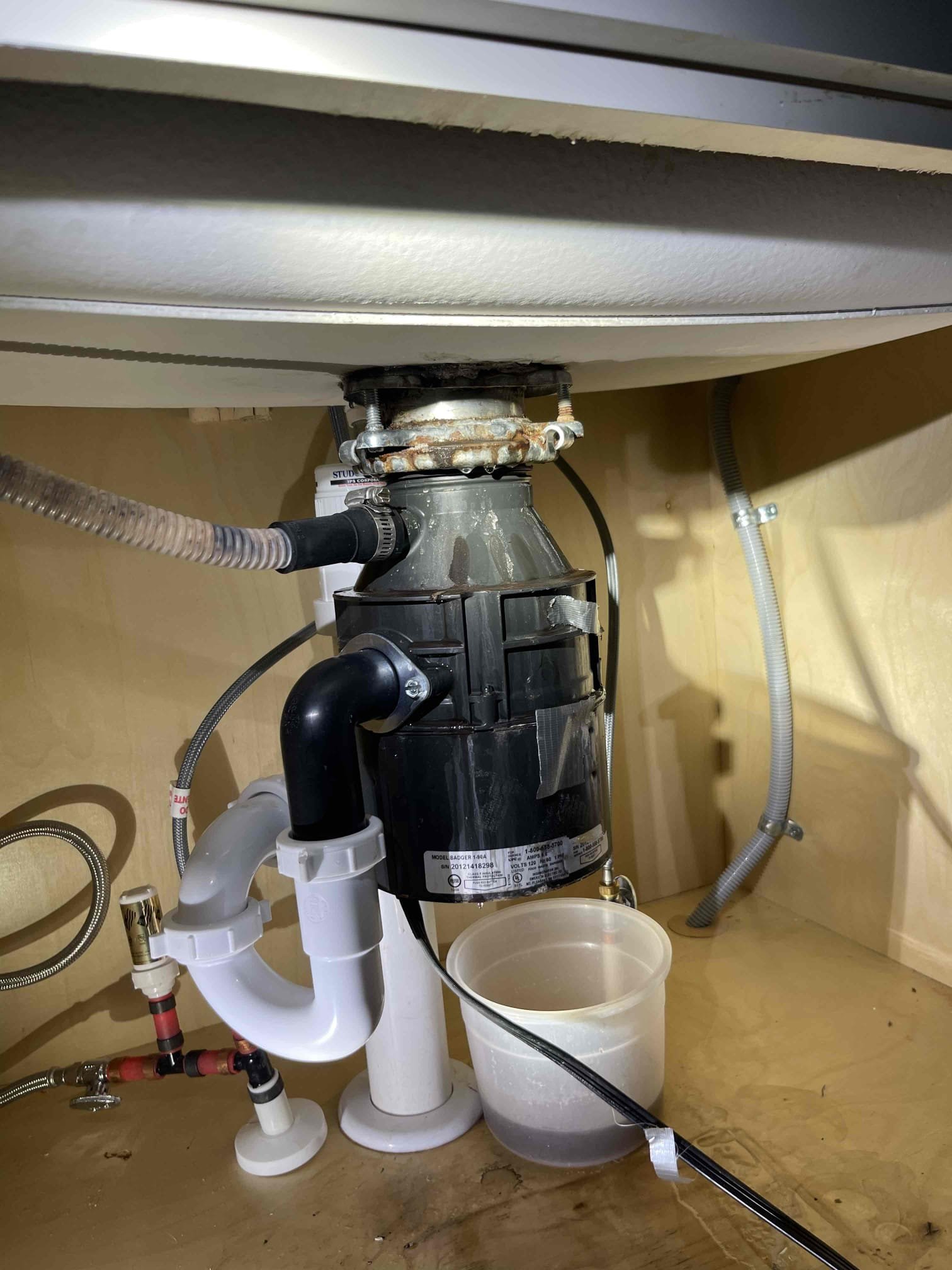 Disposal mounting bracket rusted out and was leaking. Removed disposal, installed new mounting bracket, reinstalled same disposal. Tested to ensure a leak free install and proper function of the disposal. No further issue at this time. 