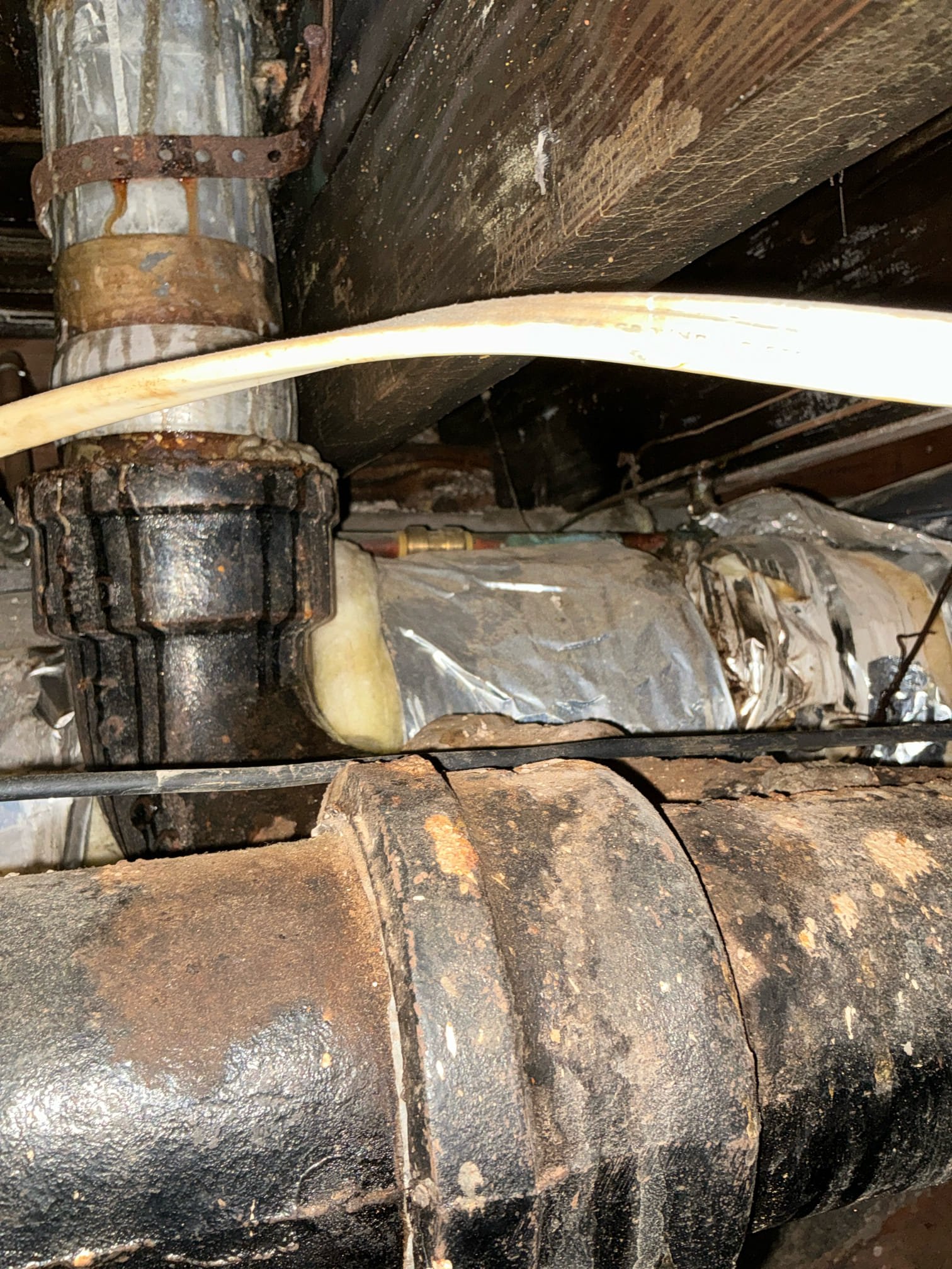 Customer is having water show up in crawlspace underneath toilet. Investigated and found widespread water damage to flooring. Customer had not used toilet today yet. There was constant drip coming down. Half inch water supply for toilet directly drilled through support beam.  Cut and capped off half inch line. Connected to customer with a reliable restoration for water damage mitigation. Gave estimate for cast-iron roof replacement and new waterline for toilet.