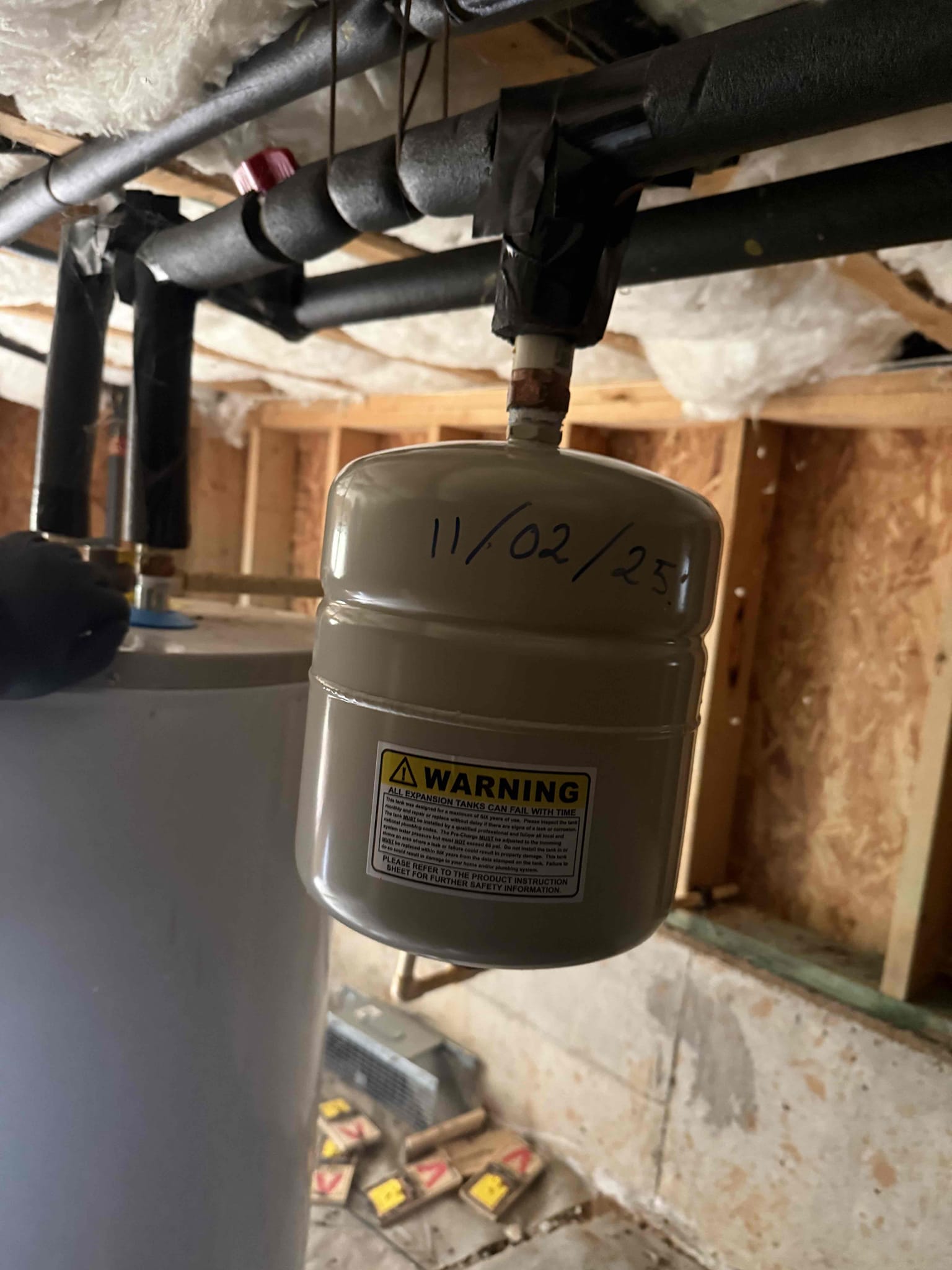 Homeowner and her father state that they purchased a new fridge for the kitchen and when the install crew moved the old fridge the ice maker angle stop was leaking so they called us to fix the issue. Upon arrival the father greeted me on driveway and explained the situation and showed me to the kitchen area. I could see they had a towel down and had shut off the water in crawl space. I did my inspection and found that the expansion tank was blown and the PRV was very old. I offered some solutions to them and they opted to install a new ice maker box PRV and shut off and finally a new expansion tank. I began with removing the old angle stop and cut the back wall to install the ice maker box and drilled a hole down to the crawl space and feed new pex pipe and connected it to the CPVC line. Then I moved to the main shut off and removed it along with the PRV and installed a pex adapter and ran new pex pipe with a new PRV and main shut off. They opted to simply replace the expansion tank an