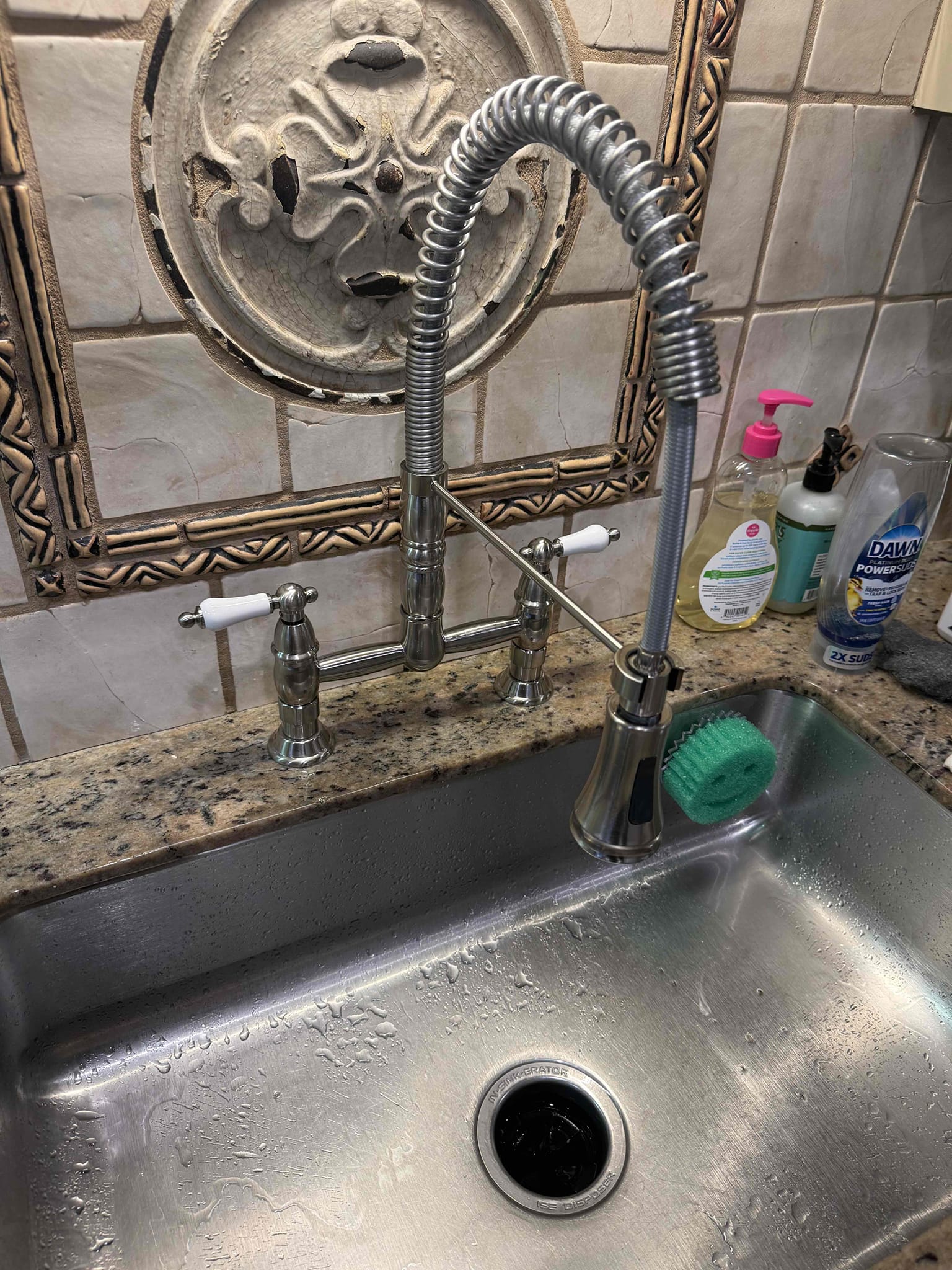 Homeowner states that the kitchen faucet was leaking from the hot side and shut it off and bought a new kitchen faucet. Upon arrival homeowner greeted me at door and showed me the kitchen faucet and the new one she had purchased and asked me to replace it. I agreed and she also agreed to the solution and I did my inspection and didn’t find anything else wrong except an old saddle valve that will need to be removed at some point on the EWH cold side above old shut off which I did inform homeowner and they will do at a later time. I began by shutting off the water and removing the old kitchen faucet along with the supply lines and cleaned the holes. I then placed the new faucet and tightened down the screws on the underside and connected new supply lines. Once I had it properly connected I turned on the water and it works properly and I tightened down all the set screws on the faucet. The water pressure is a bit low which homeowner is aware of and they decided to increase the pressure at