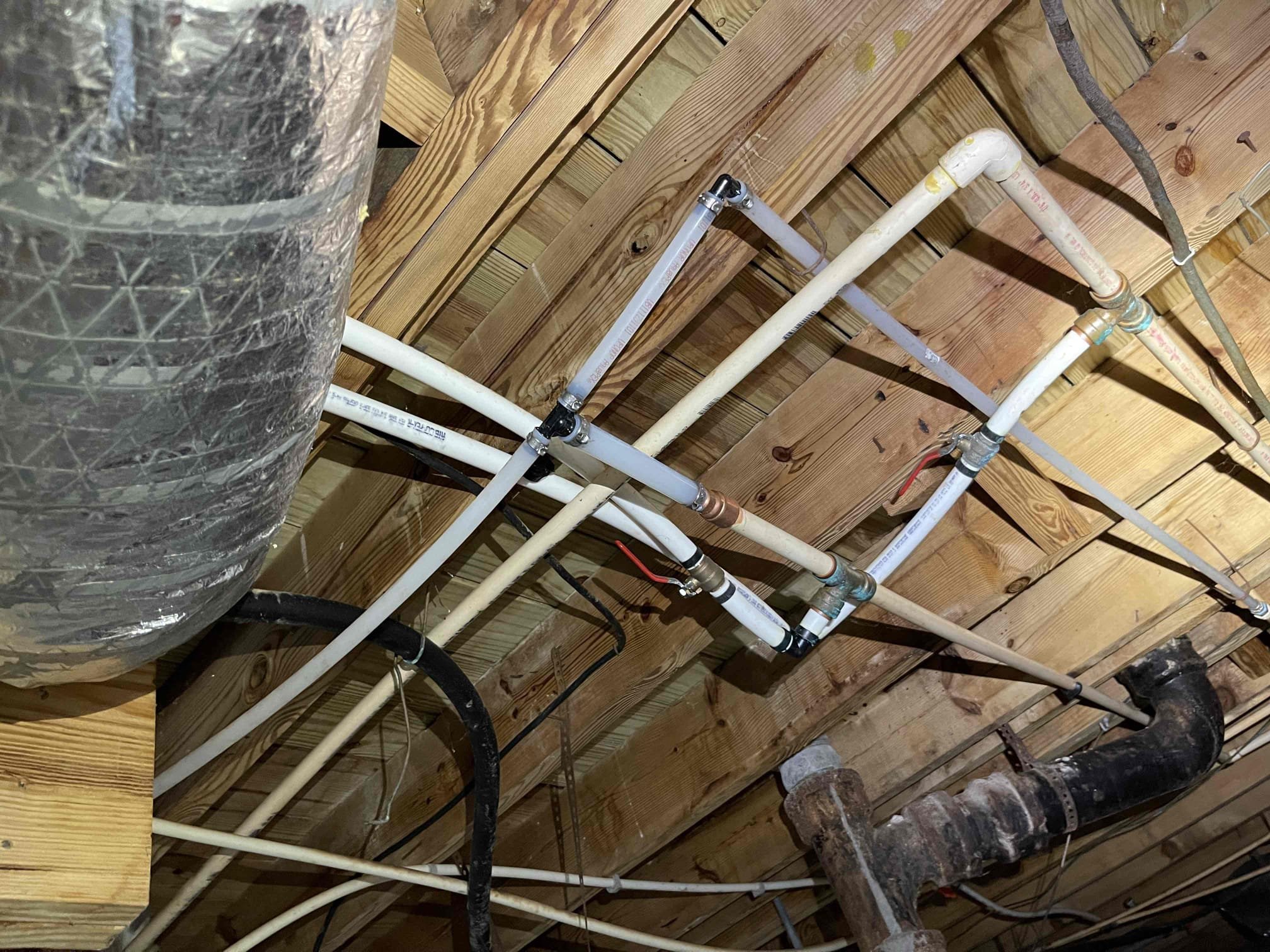 Repiped some sections of Cpvc hot and cold piping in crawlspace to remove all of the slow dripping fittings. Waited for glue to cure before testing. No further issue at this time. Very old tankless water heater. Left quote to replace. 