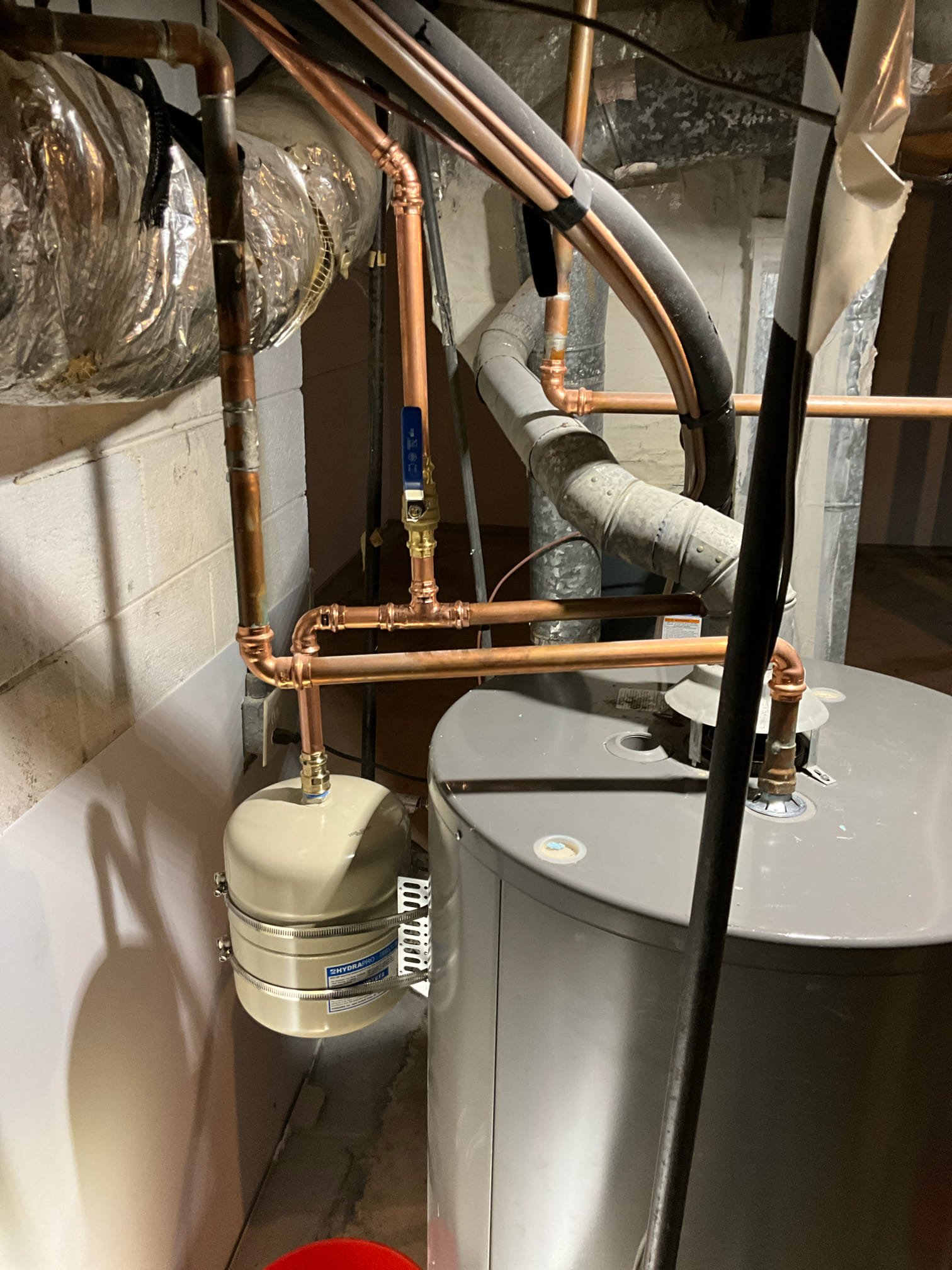 Call for sump pump inspection.

Arrived and discussed concerns with Michael on site. He stated that a sump pump was installed in the basement approximately a year ago, in conjunction with other waterproofing and water diversion efforts. He wants to have the pump and system inspected.

While inspecting the pump, I found rocks and debris in the basin. No check valve is present on the discharge line. The pump functions normally, and does not appear to be damaged or dis functional in any way. The basin is intact, no cracks, with the exception of intentionally drilled holes for water. While performing routine check of water pressure I found the pressure to be ~80psi at 9am. The pressure regulating valve is extremely corroded. Thermal expansion tank bladder was ruptured, and rusty water was discharged at air port. There is also extreme corrosion along copper lines.

I discussed concerns, risks, and solutions with Michael. He has elected to install the Moen Flo automatic leak detection device