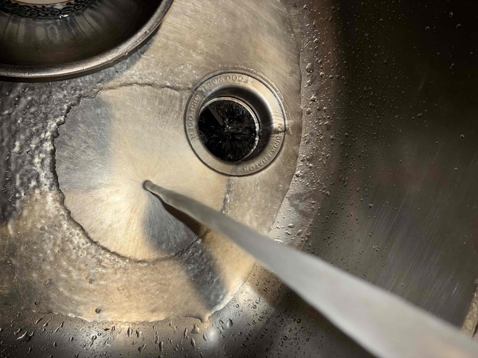 Customer had garbage disposal go back and leak out side of disposal. Suggested to replace disposal to fix issue. Also found heater of 2008. Inside bedroom closet. Recommended to replace due to age and location of heater. After replacement of heater and thermal expansion tank with new bracket, checked for leaks and proper function. Took of trim to get heater installed in closet. Put back trim and recauked trim. Checked with customer for satisfaction of trim replacement. 