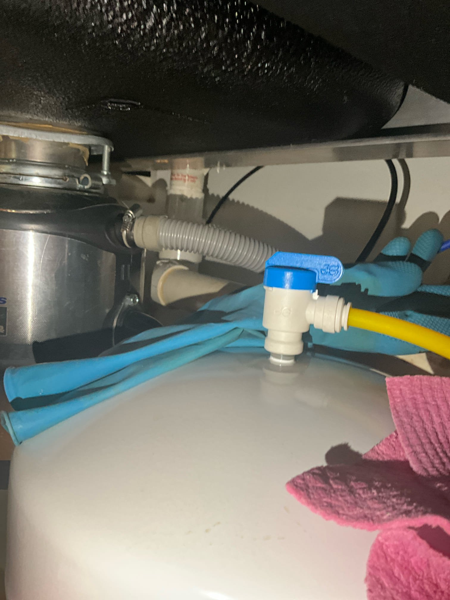 Customer had a sewer smell coming from kitchen sink area. Inspected the area, saw no heavy buildup on the tubular, and no dried out traps. Diagnosed a failed AAV. Recommended replacement of the AAV. Customer requested changing all the pvc under the sink instead. Gave customer price to replace the strainer, the traps, the other tubular, and the pvc all the way to the cast stub out in the cabinet (cast runs through several inches of concrete). Customer approved work. Reworked pipes for both sides to tie into a common trap as well as drilling the drain for the reverse osmosis into the vent instead of directly into an active horizontal drain. Tested all work to ensure proper function and no leaks. Customer was dissatisfied with the new strainer. Customer would like his previous sink strainer installed. The ring had to be cut off to remove the old strainer. Will have to find a nut to put the old strainer back and will return to install the old strainer at no additional charge.  Collected pa