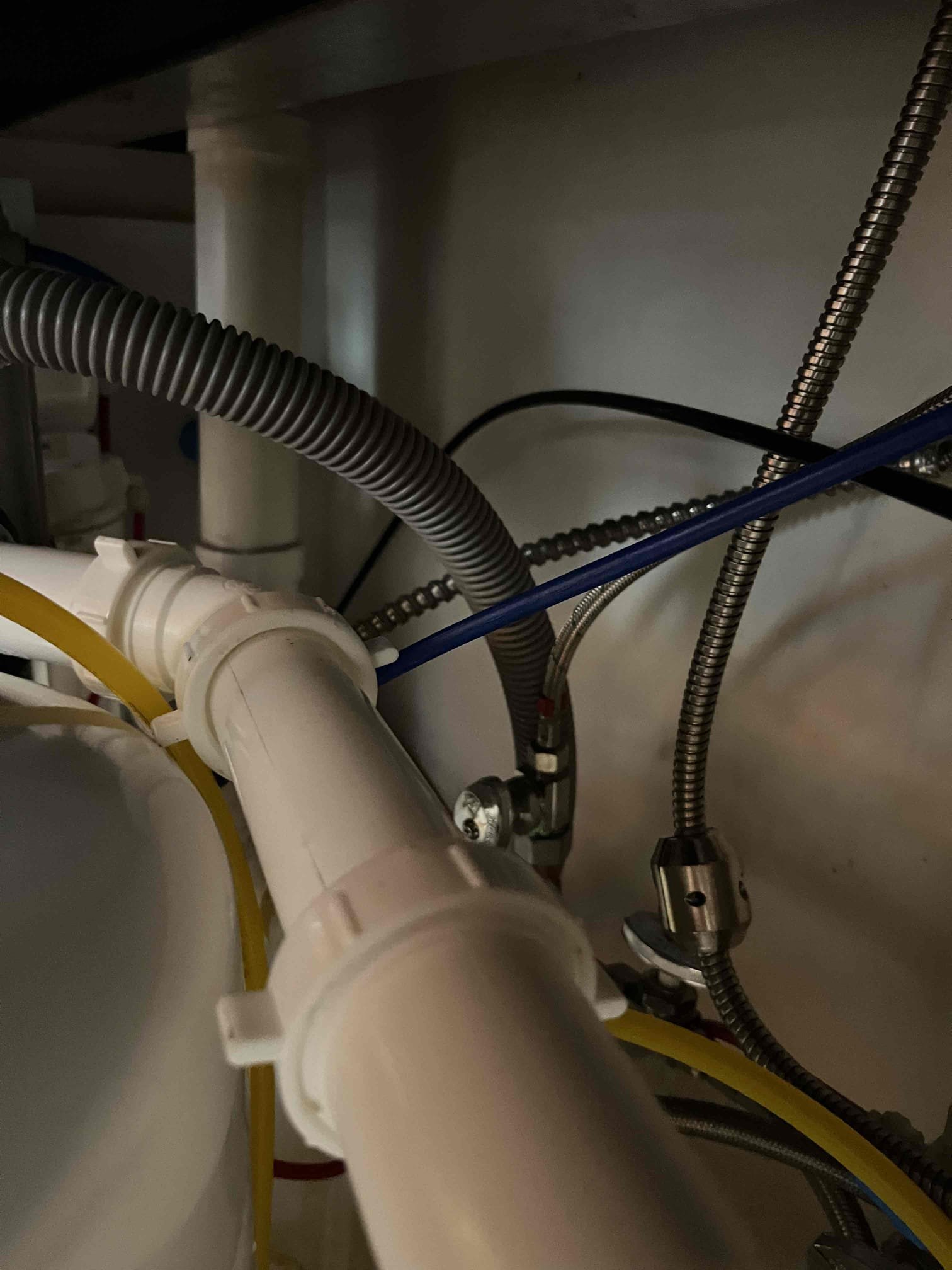 Customer had a sewer smell coming from kitchen sink area. Inspected the area, saw no heavy buildup on the tubular, and no dried out traps. Diagnosed a failed AAV. Recommended replacement of the AAV. Customer requested changing all the pvc under the sink instead. Gave customer price to replace the strainer, the traps, the other tubular, and the pvc all the way to the cast stub out in the cabinet (cast runs through several inches of concrete). Customer approved work. Reworked pipes for both sides to tie into a common trap as well as drilling the drain for the reverse osmosis into the vent instead of directly into an active horizontal drain. Tested all work to ensure proper function and no leaks. Customer was dissatisfied with the new strainer. Customer would like his previous sink strainer installed. The ring had to be cut off to remove the old strainer. Will have to find a nut to put the old strainer back and will return to install the old strainer at no additional charge.  Collected pa